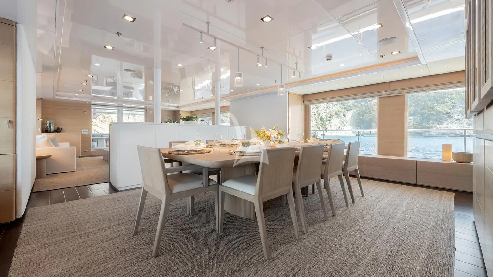 a large room with a table and chairs aboard ZIA Yacht for Sale