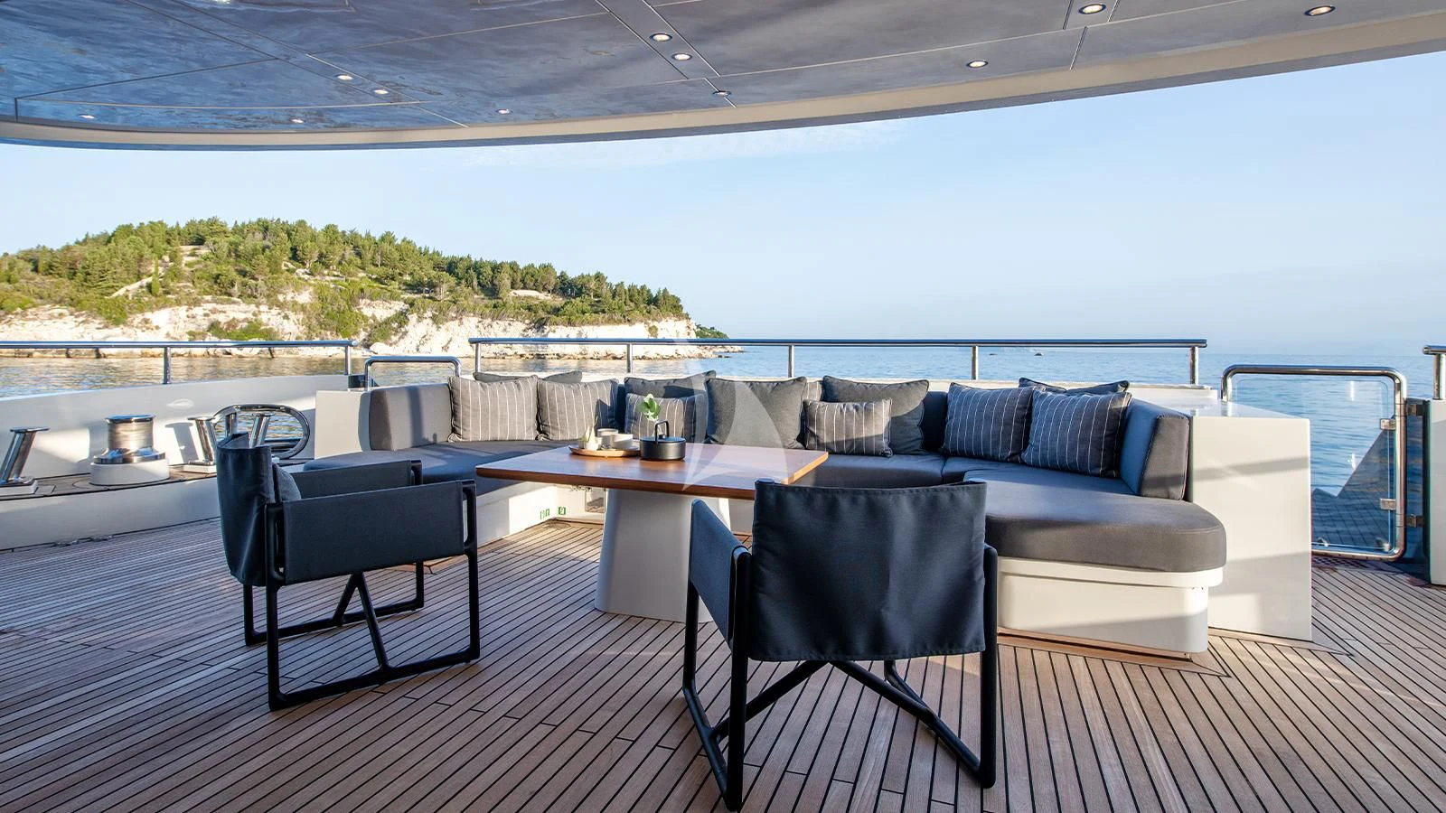 a deck with chairs and tables aboard ZIA Yacht for Sale