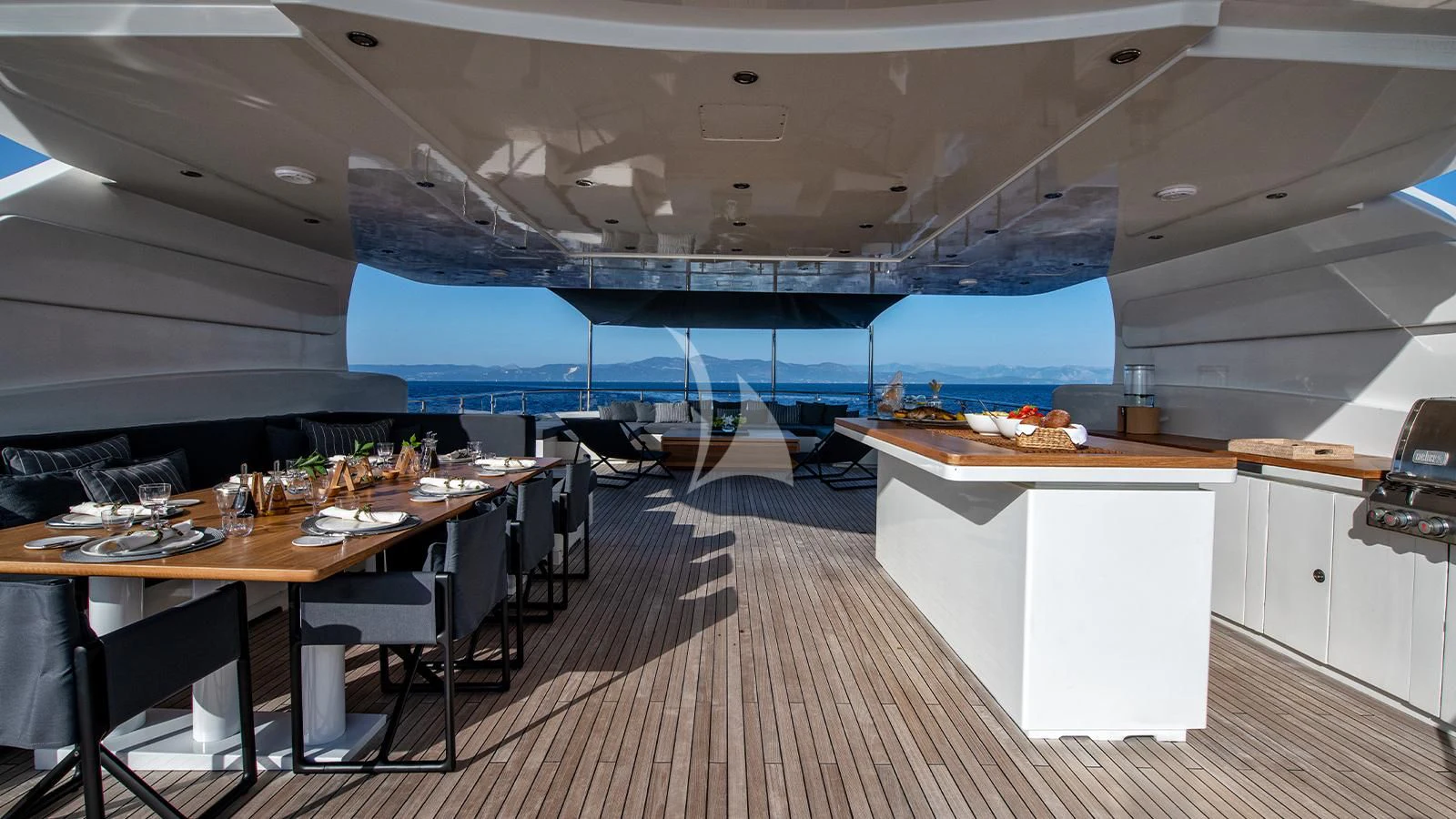 a room with tables and chairs aboard ZIA Yacht for Sale