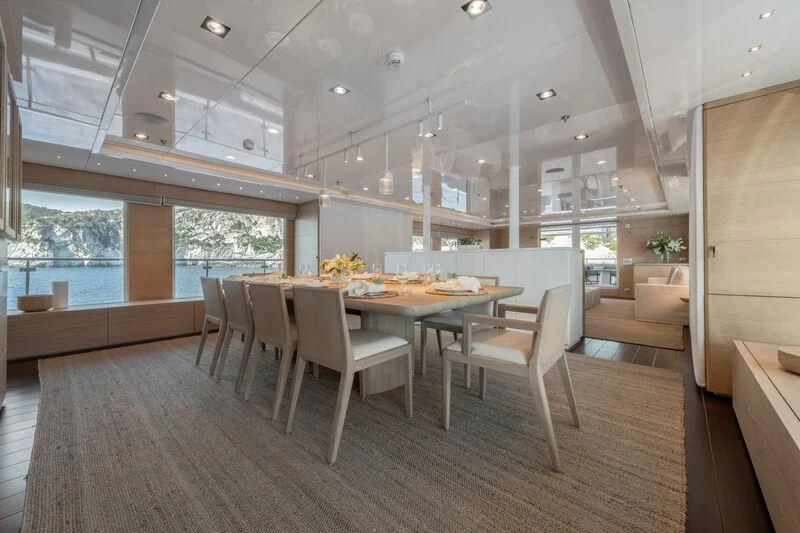 a large kitchen with a table and chairs aboard ZIA Yacht for Sale