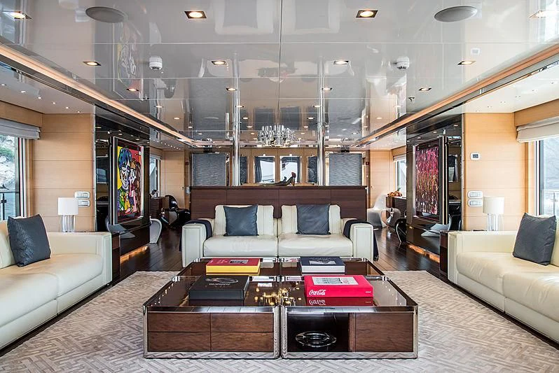 a living room with a table and couches aboard ZIA Yacht for Sale