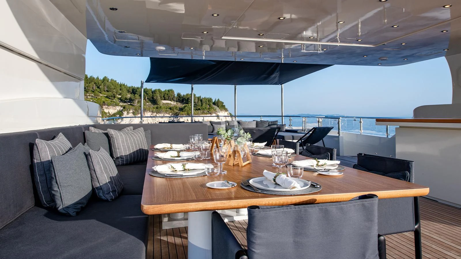 a table with plates and glasses on it aboard ZIA Yacht for Sale
