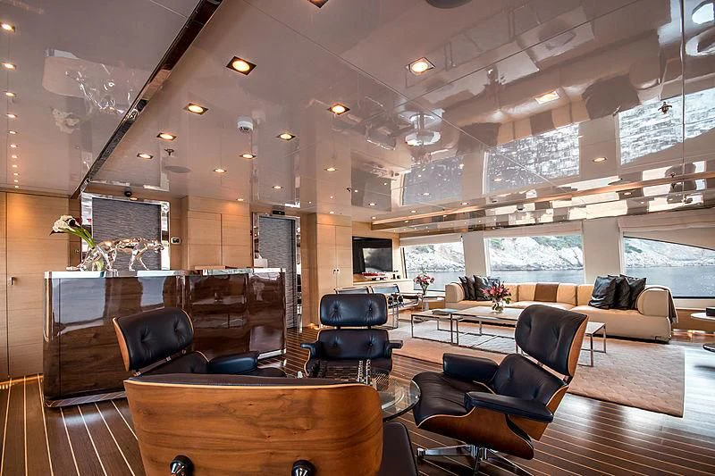 a room with leather couches and a large window aboard ZIA Yacht for Sale