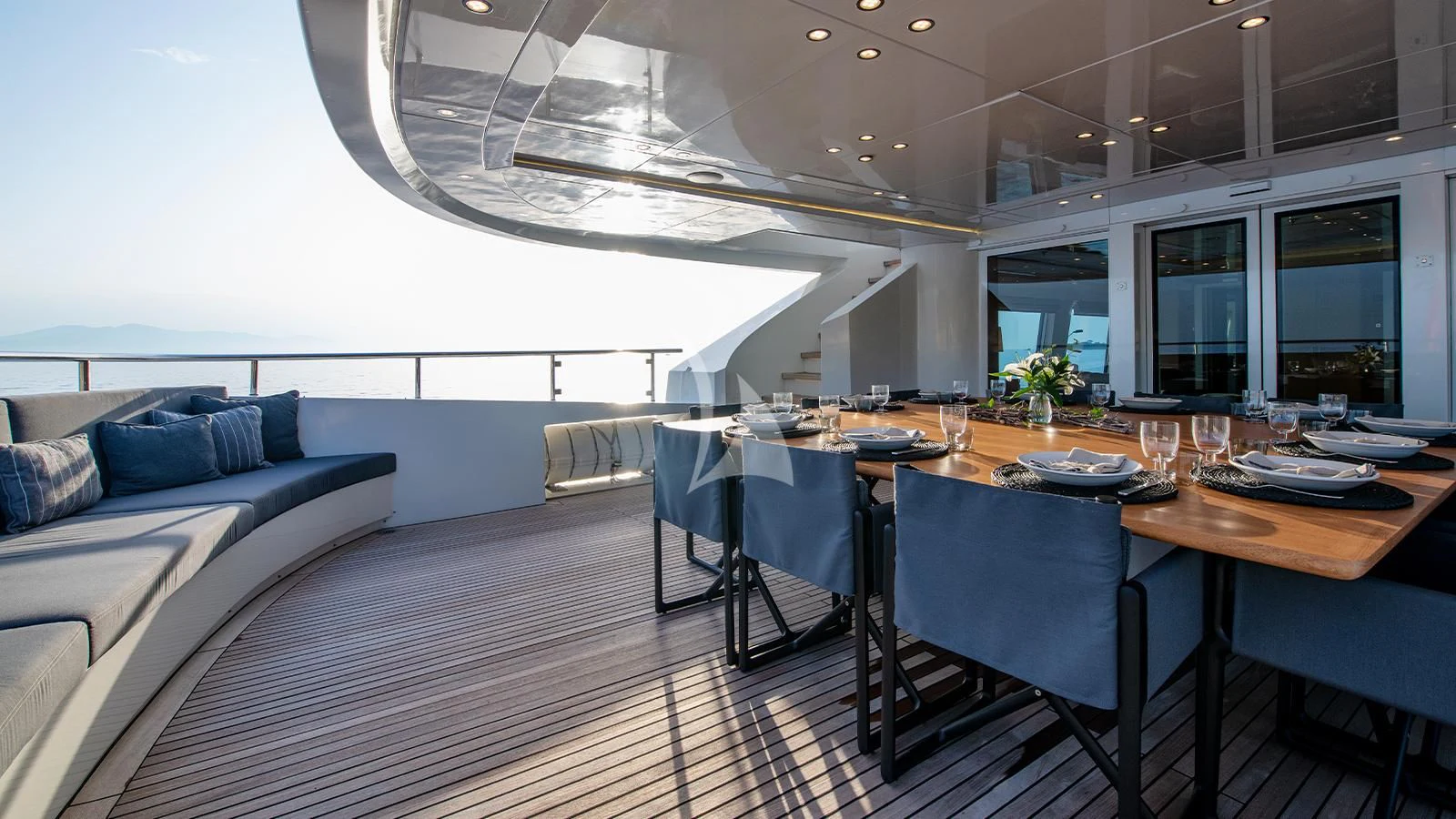 a large room with a table and chairs aboard ZIA Yacht for Sale