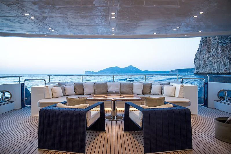 a large room with a couch and a table and chairs aboard ZIA Yacht for Sale