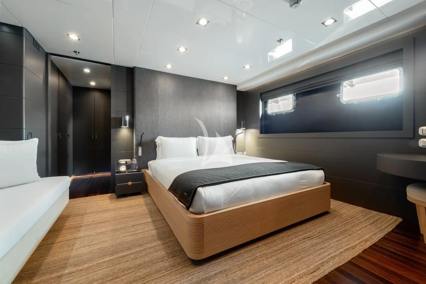 a room with a bed and a large mirror aboard ZIA Yacht for Sale
