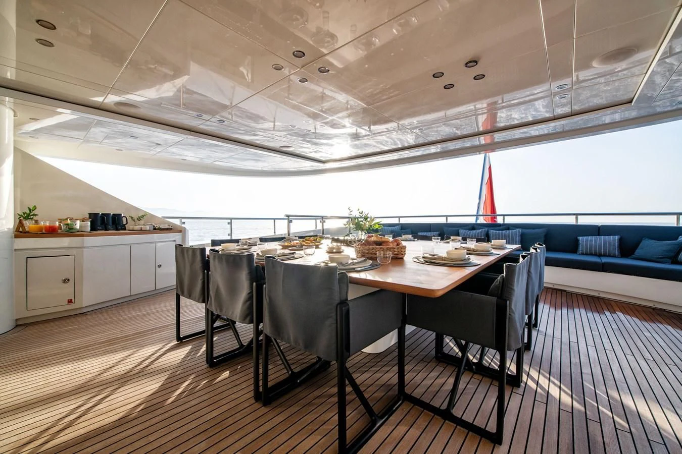 a large kitchen with a table and chairs aboard ZIA Yacht for Sale
