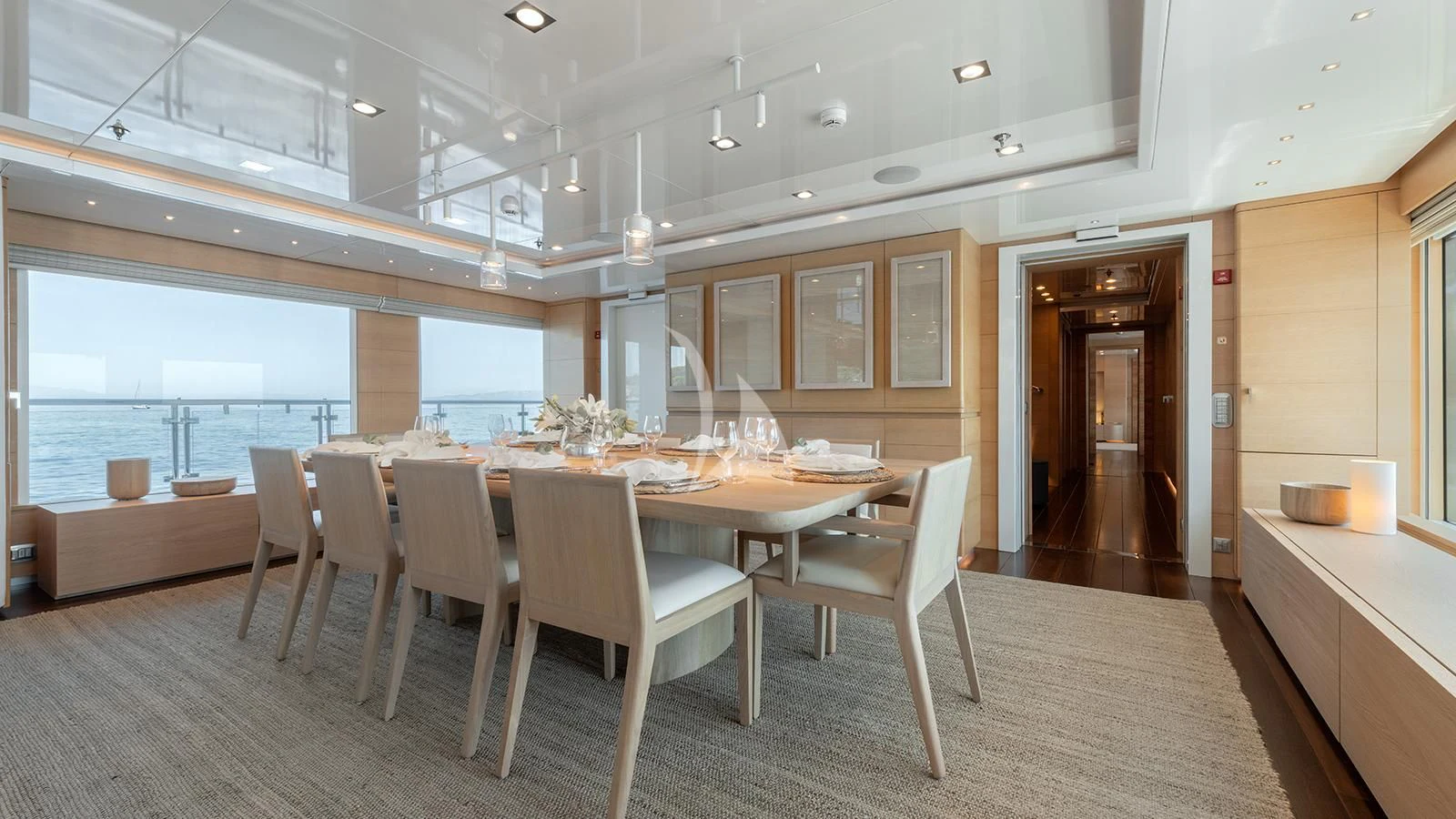 a large room with tables and chairs aboard ZIA Yacht for Sale