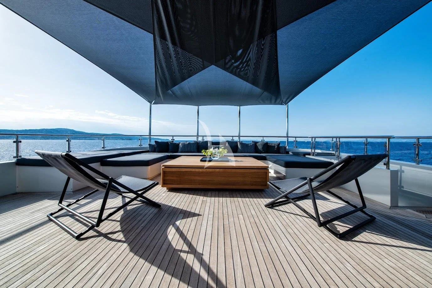 a lounge area with a table and chairs on it aboard ZIA Yacht for Sale