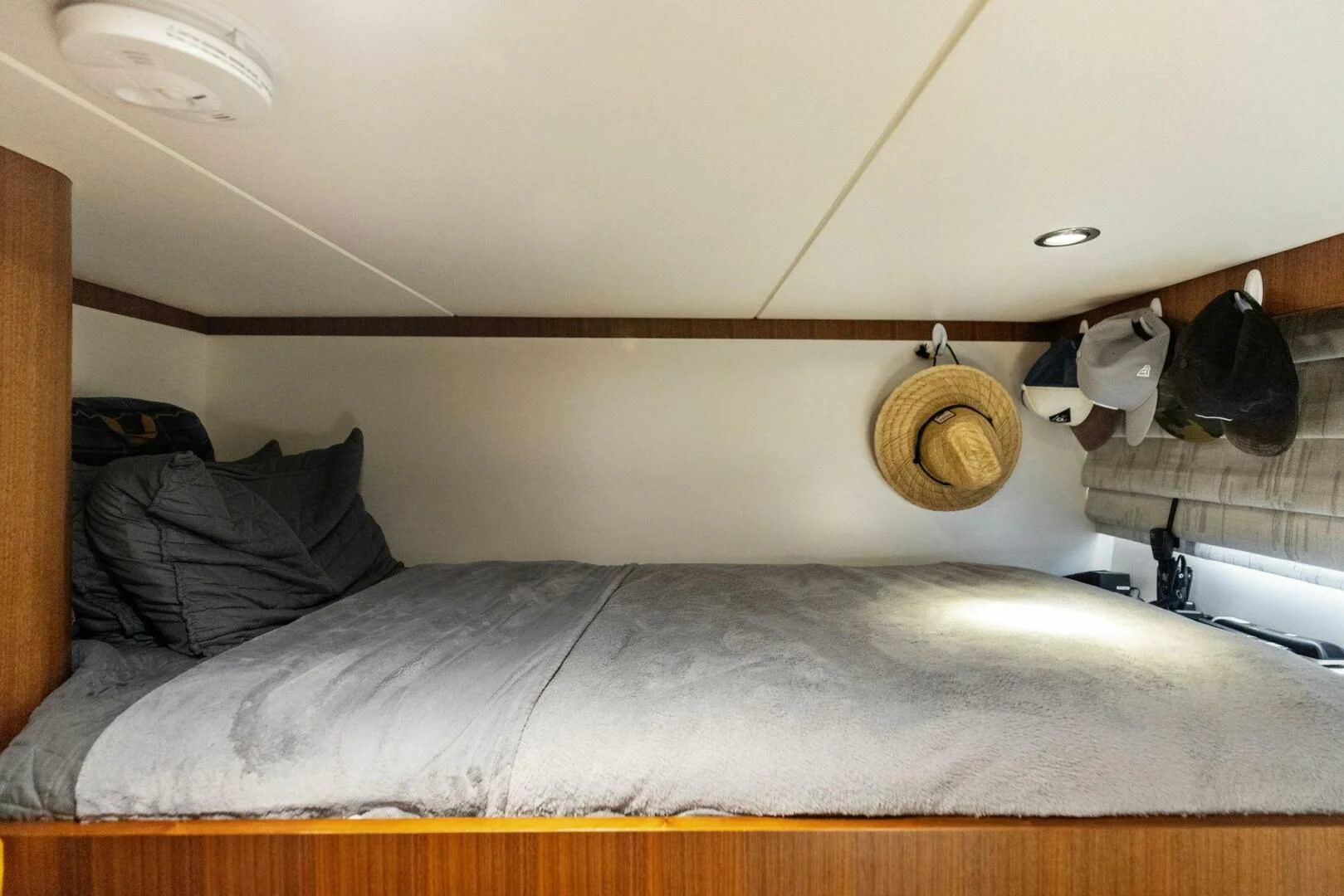 a bed with a brown pillow aboard CLAYMAKER Yacht for Sale