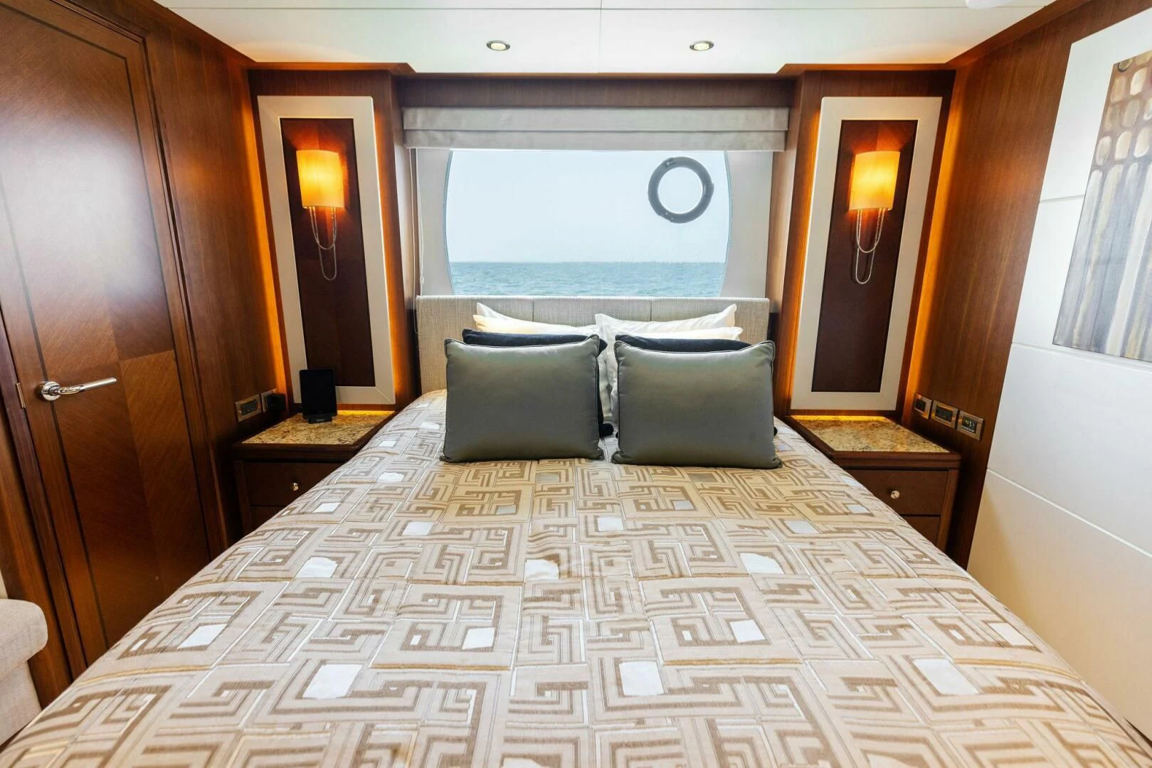a bed with a large window aboard CLAYMAKER Yacht for Sale