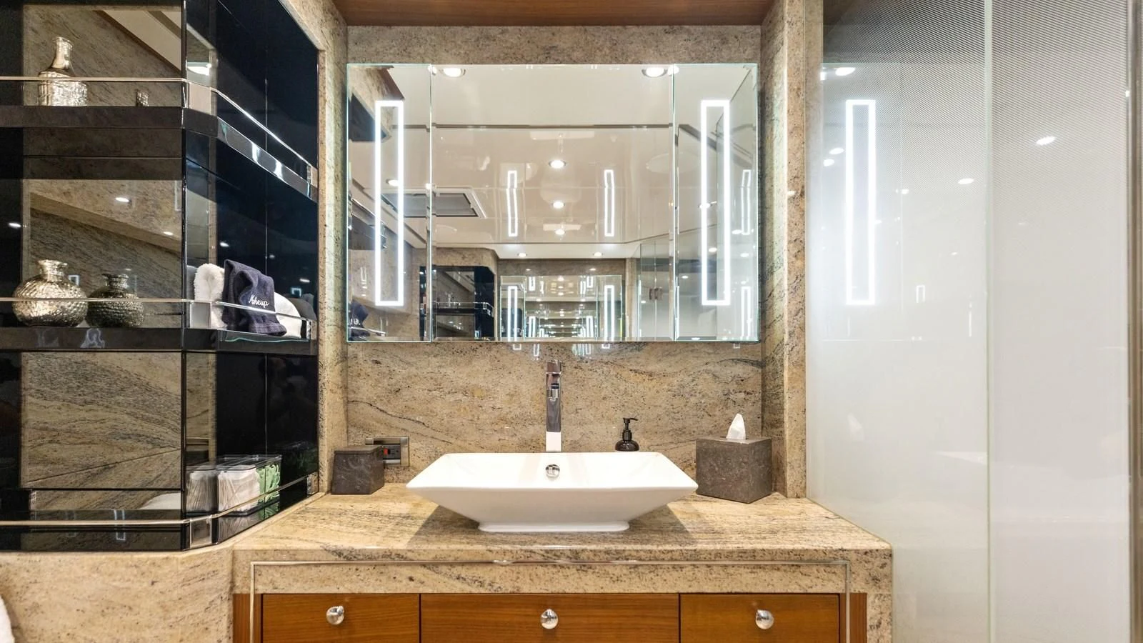 a bathroom with a large mirror aboard CLAYMAKER Yacht for Sale