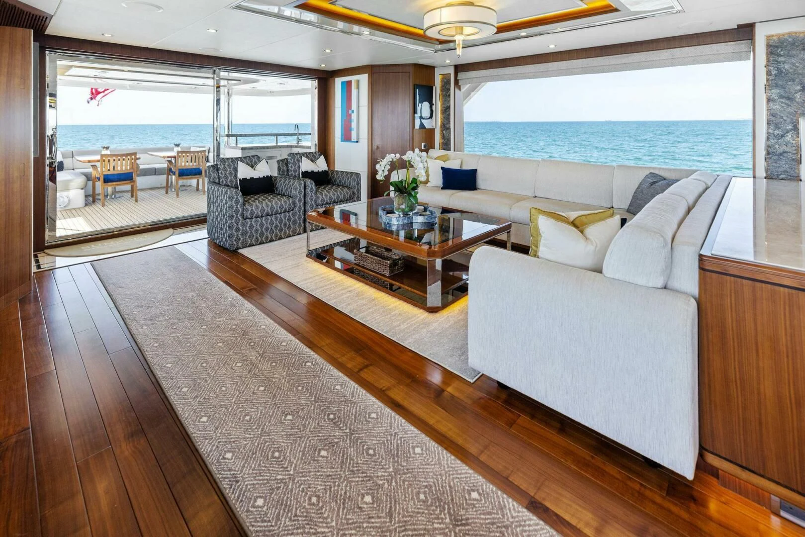 a living room with a large balcony aboard CLAYMAKER Yacht for Sale