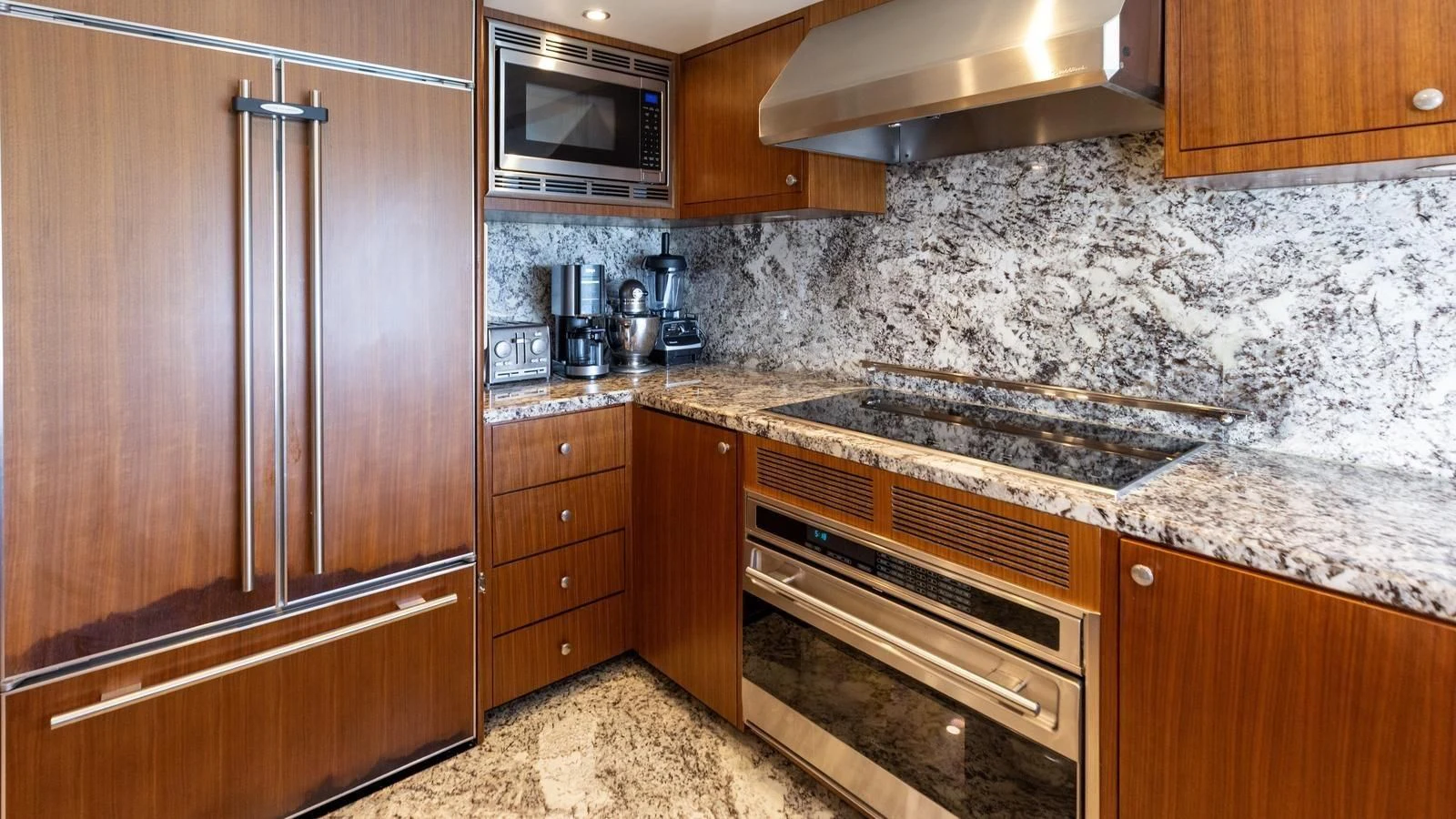 a kitchen with wooden cabinets aboard CLAYMAKER Yacht for Sale