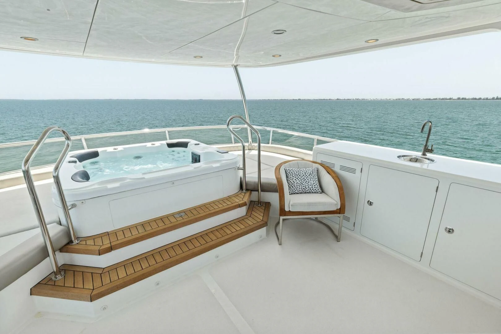 a white bathtub and a chair on a boat in the water aboard CLAYMAKER Yacht for Sale