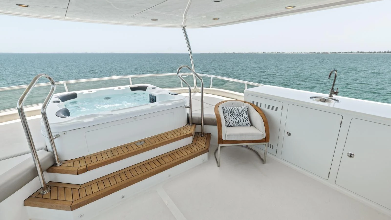 a white bathtub and a chair on a boat in the water aboard CLAYMAKER Yacht for Sale