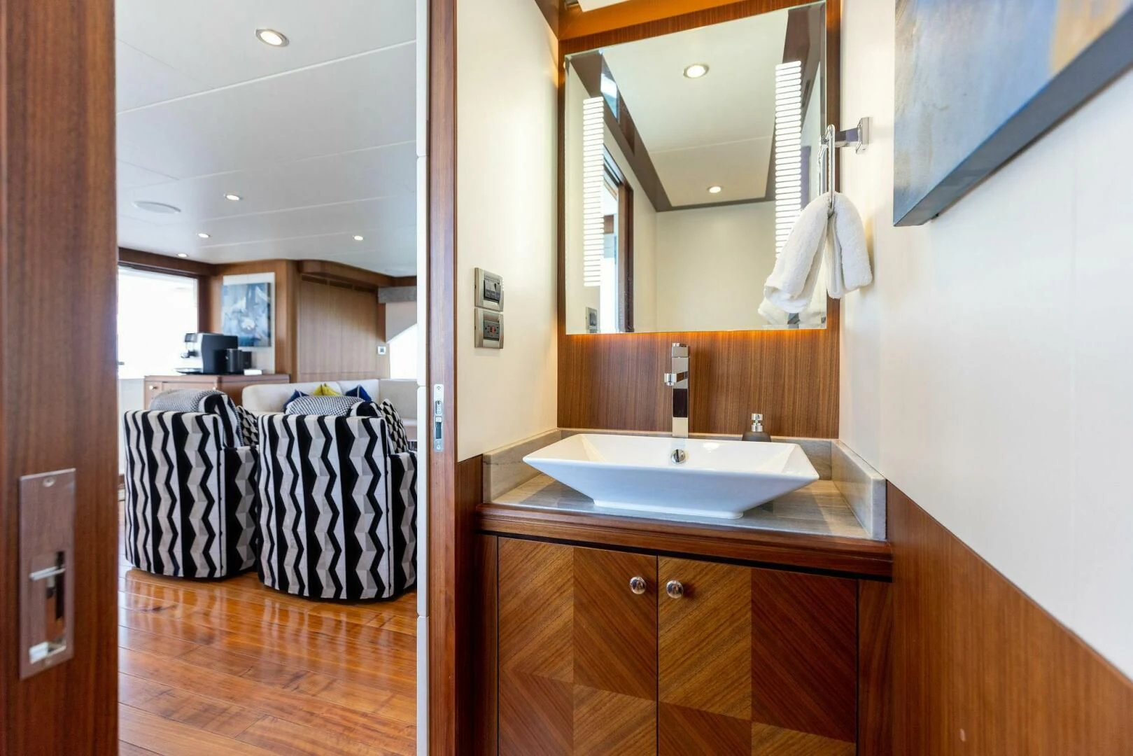 a bathroom with a sink and mirror aboard CLAYMAKER Yacht for Sale