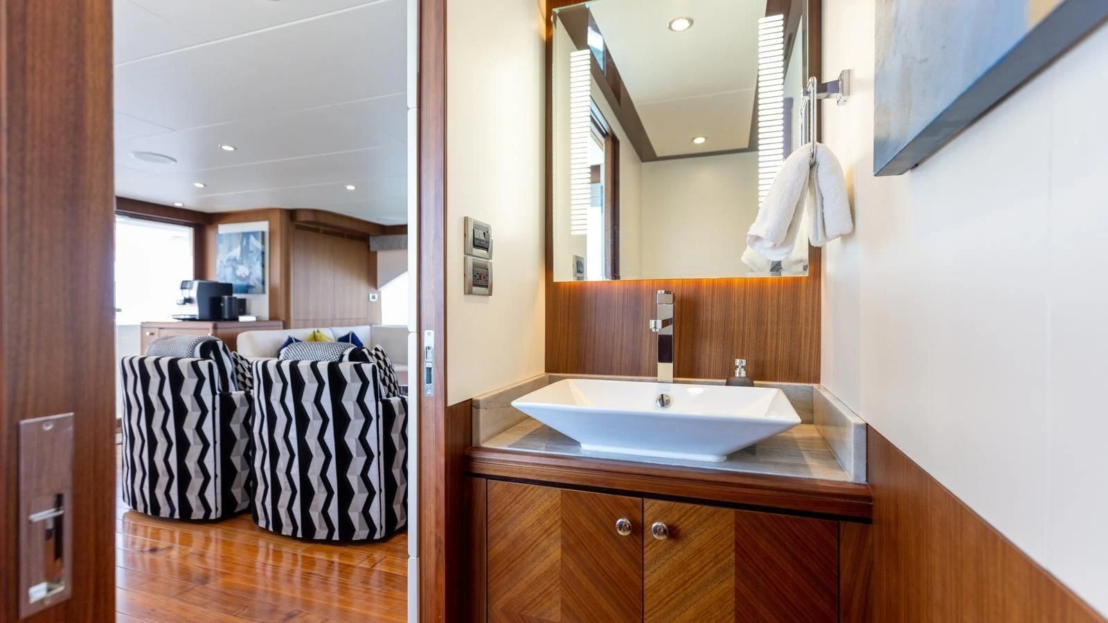 a bathroom with a sink and mirror aboard CLAYMAKER Yacht for Sale