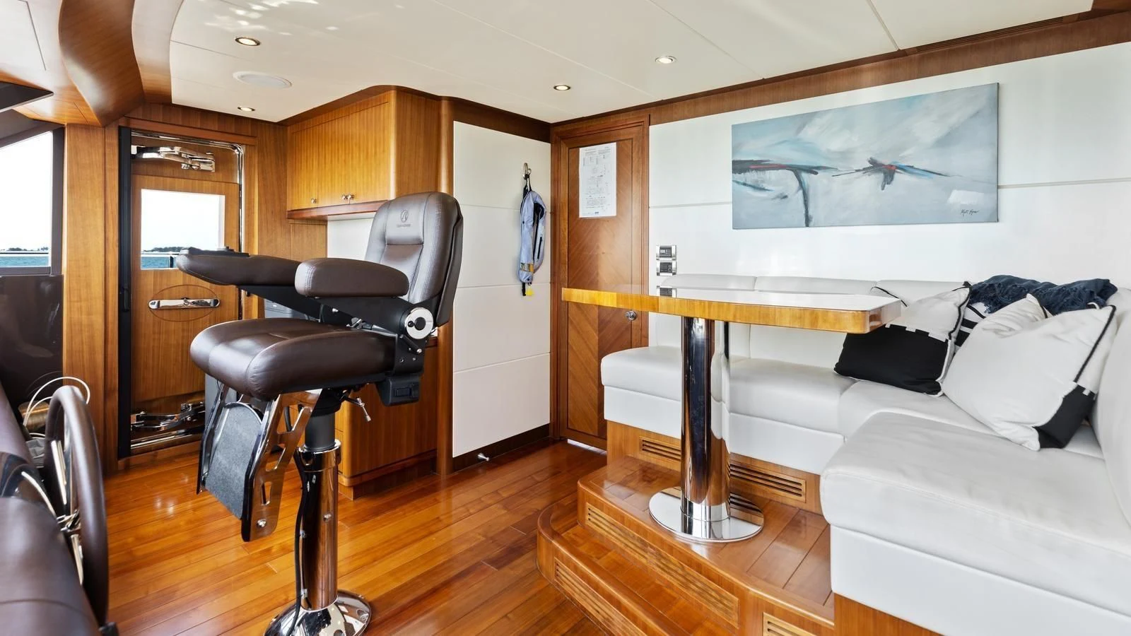 a living room with a chair and a table aboard CLAYMAKER Yacht for Sale