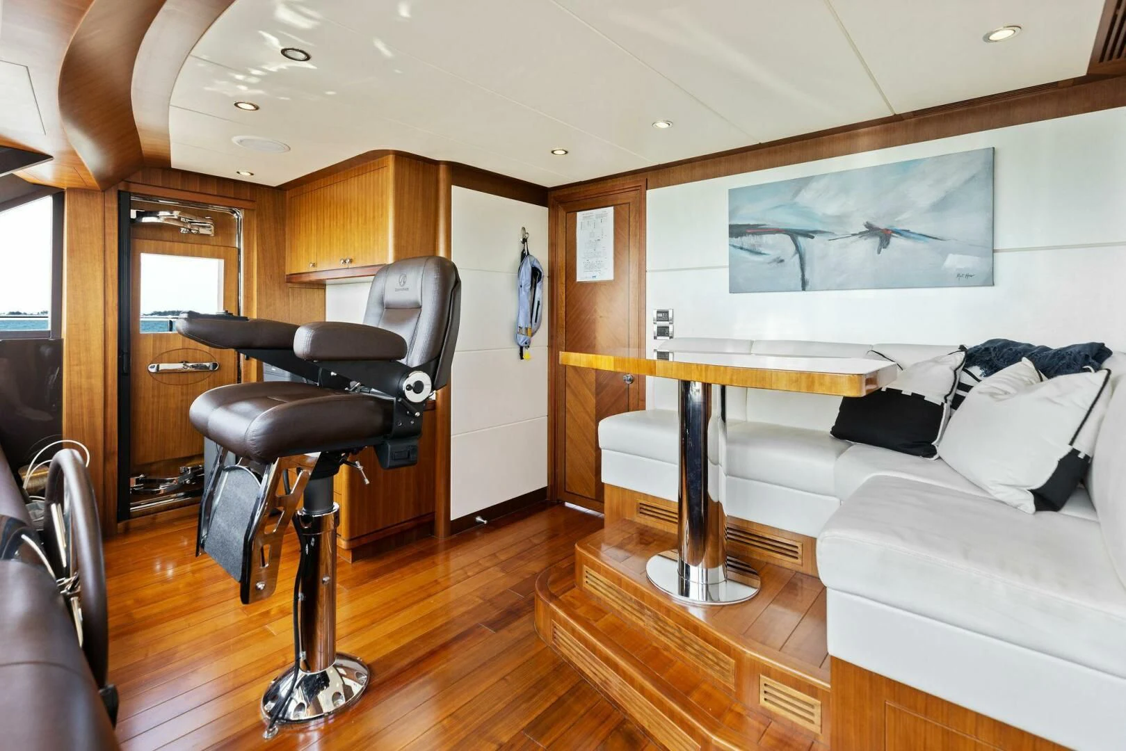 a living room with a chair and a table aboard CLAYMAKER Yacht for Sale