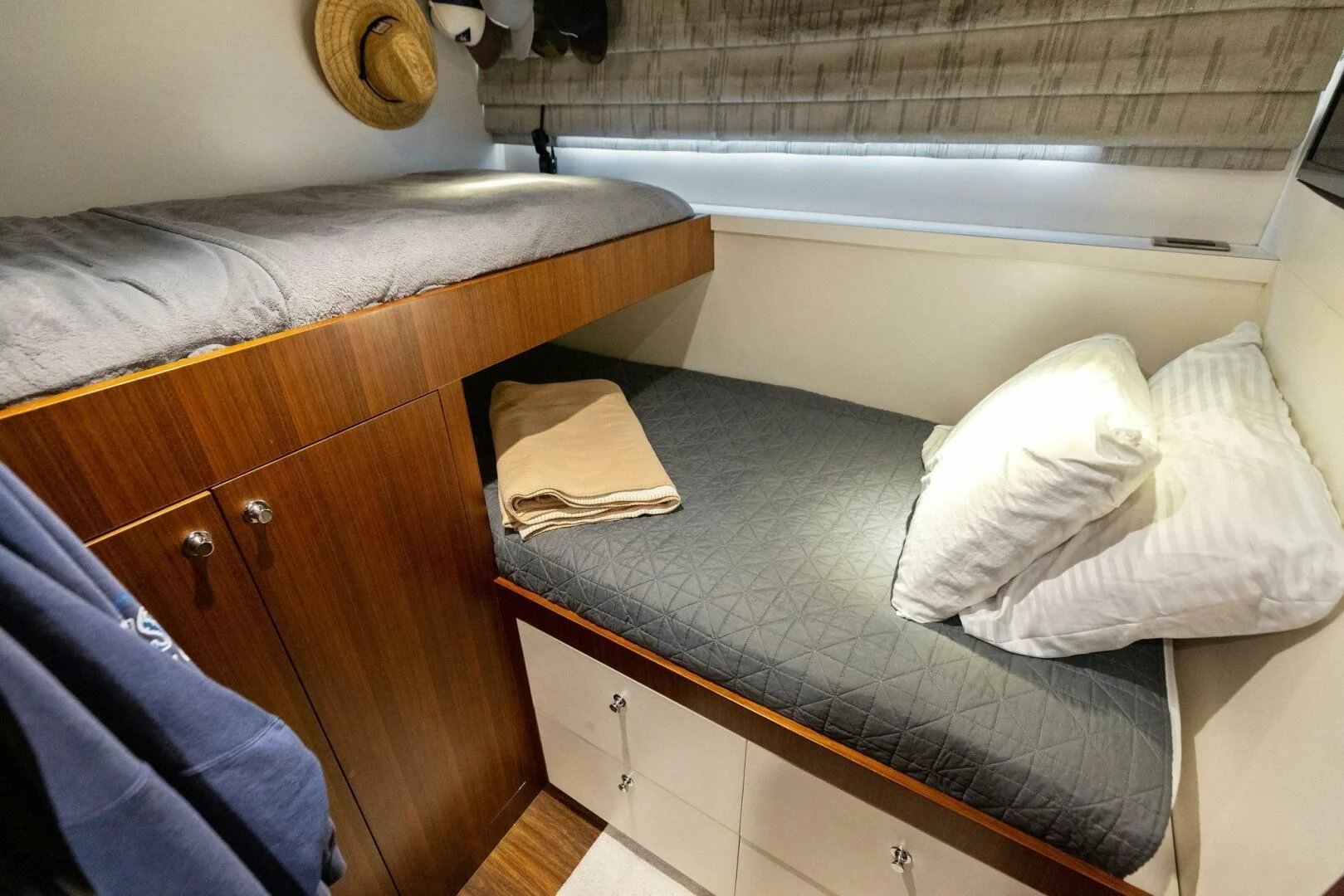 a bed with a book on it aboard CLAYMAKER Yacht for Sale