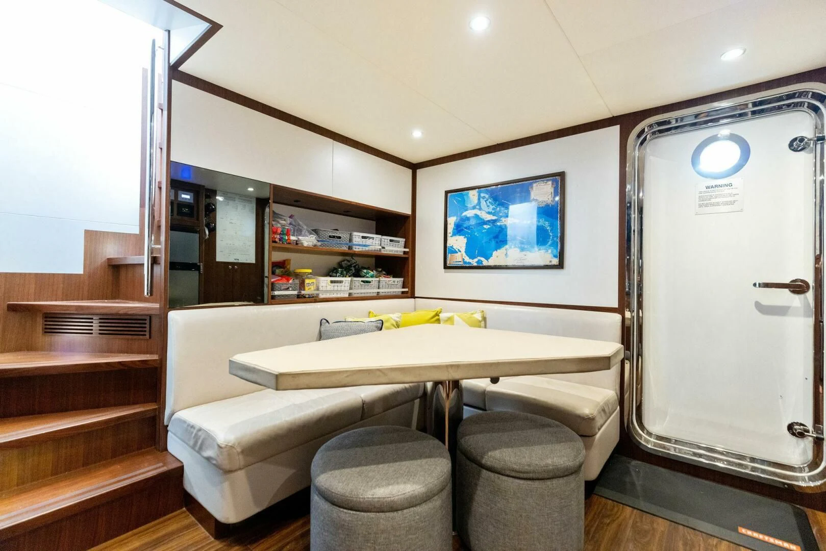 a room with a table and chairs aboard CLAYMAKER Yacht for Sale