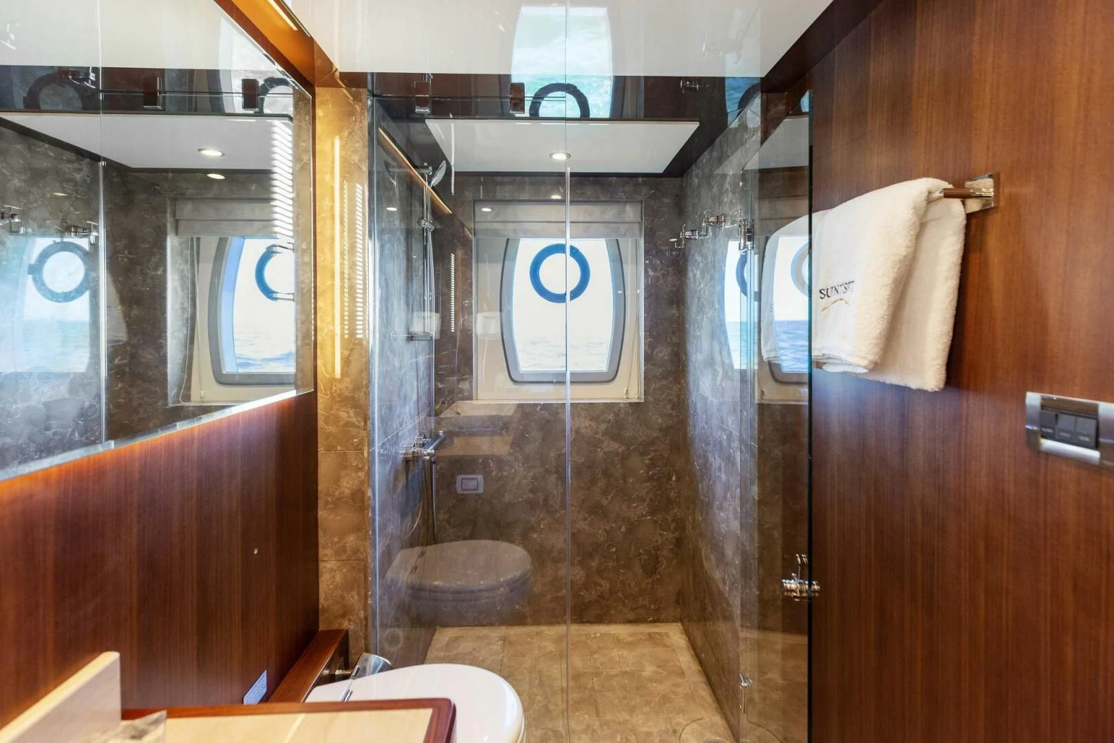 a bathroom with a glass shower aboard CLAYMAKER Yacht for Sale