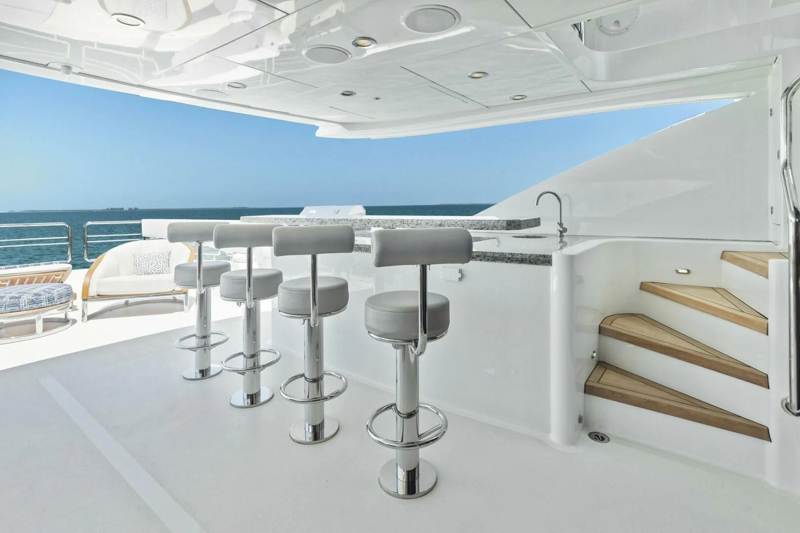 a row of stools in a room with a blue wall and a white floor aboard CLAYMAKER Yacht for Sale