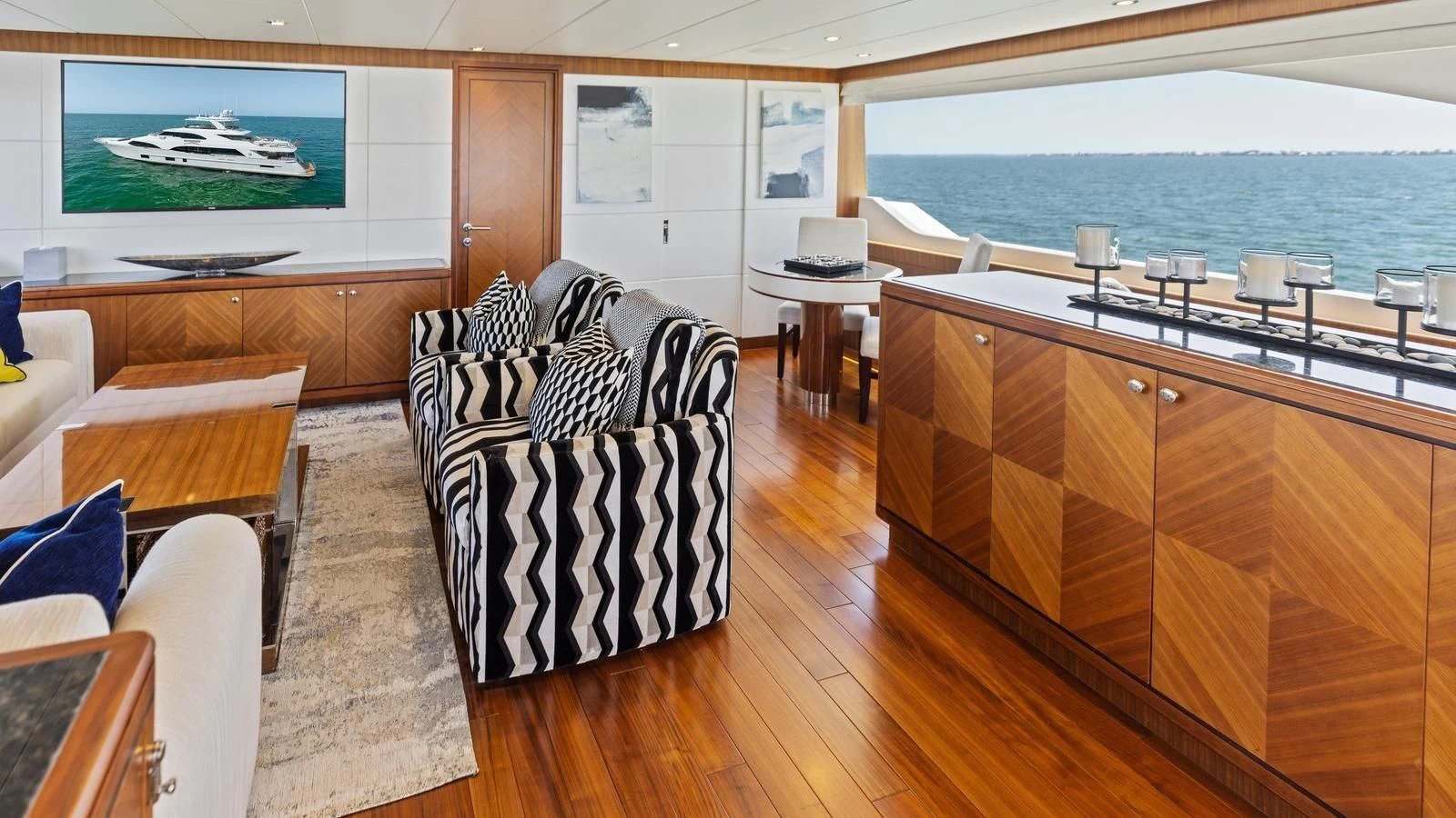 a living room with a large window aboard CLAYMAKER Yacht for Sale