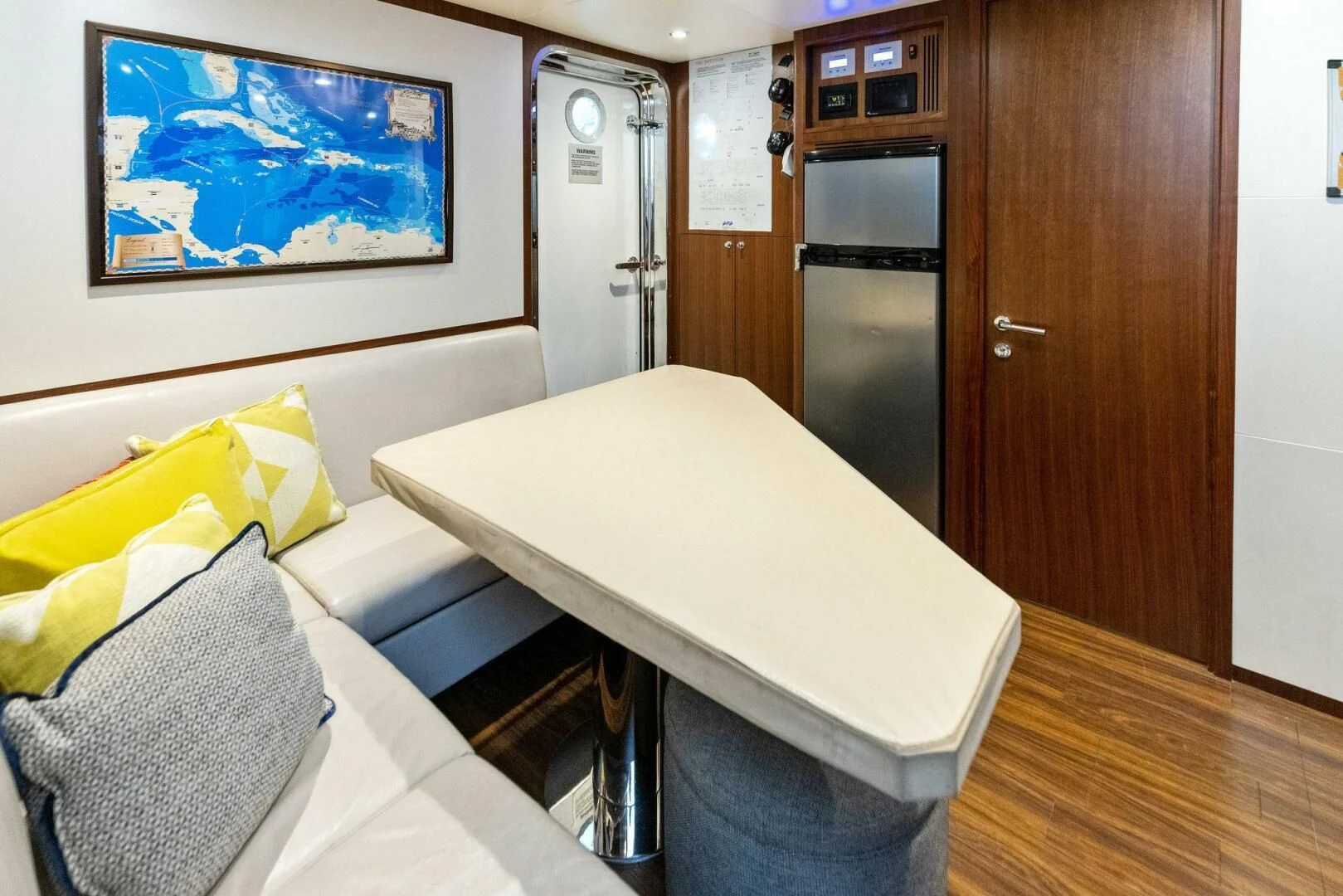 a room with a table and couch aboard CLAYMAKER Yacht for Sale