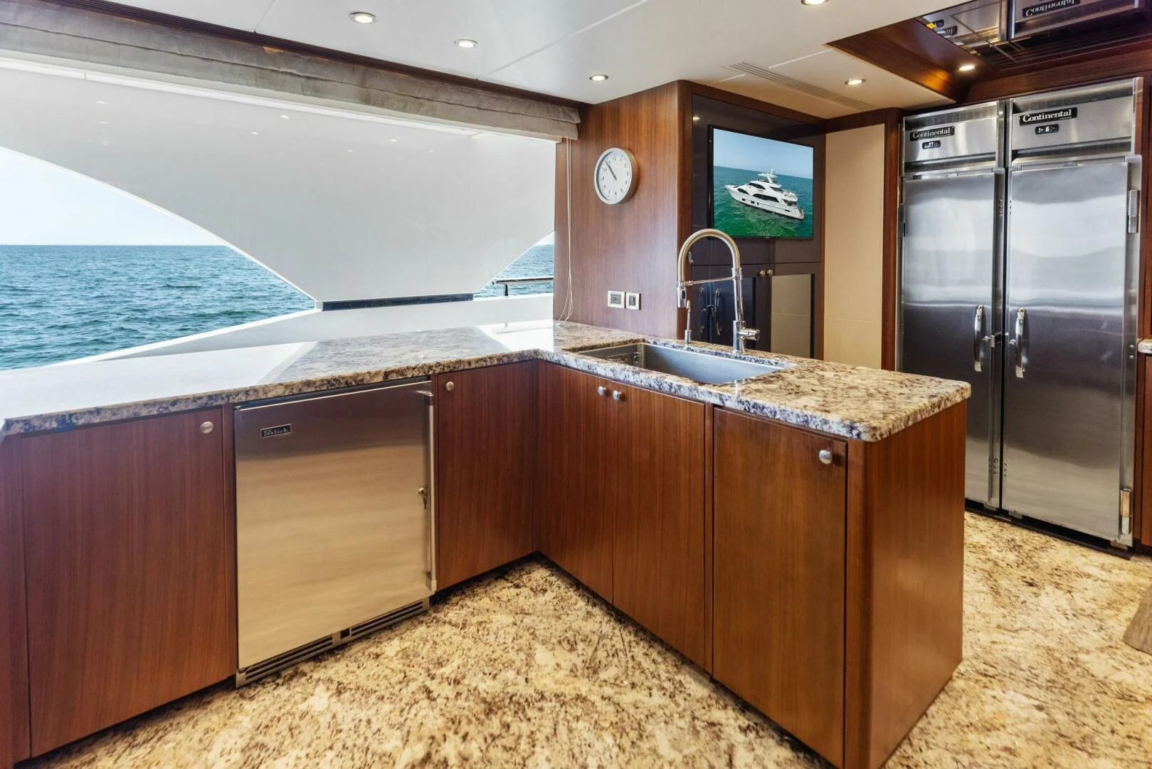 a kitchen with a large island aboard CLAYMAKER Yacht for Sale