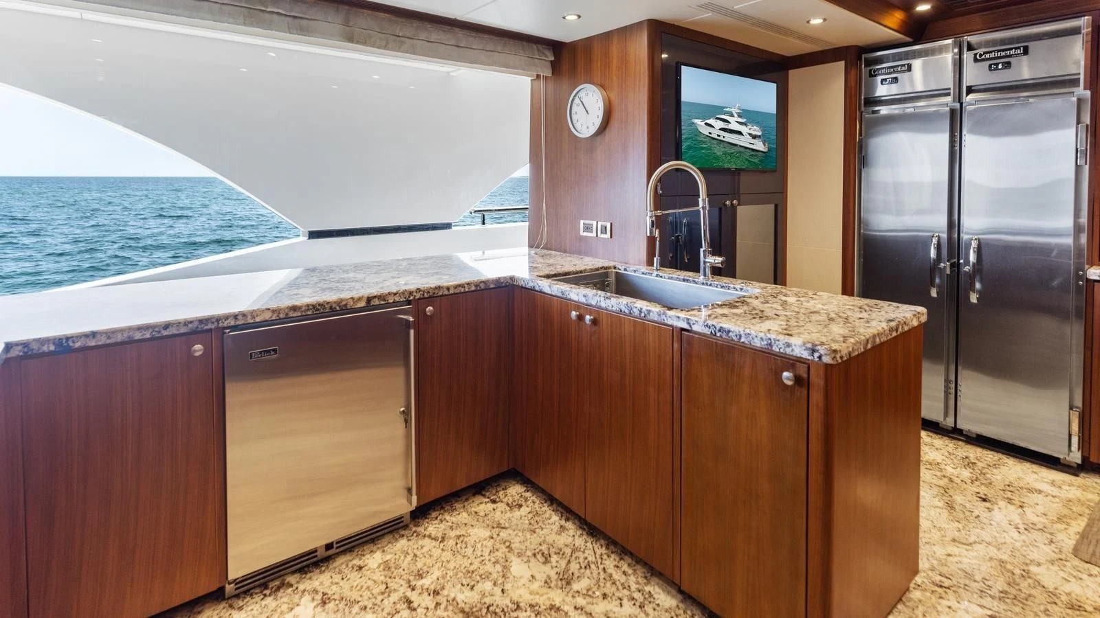 a kitchen with a large island aboard CLAYMAKER Yacht for Sale