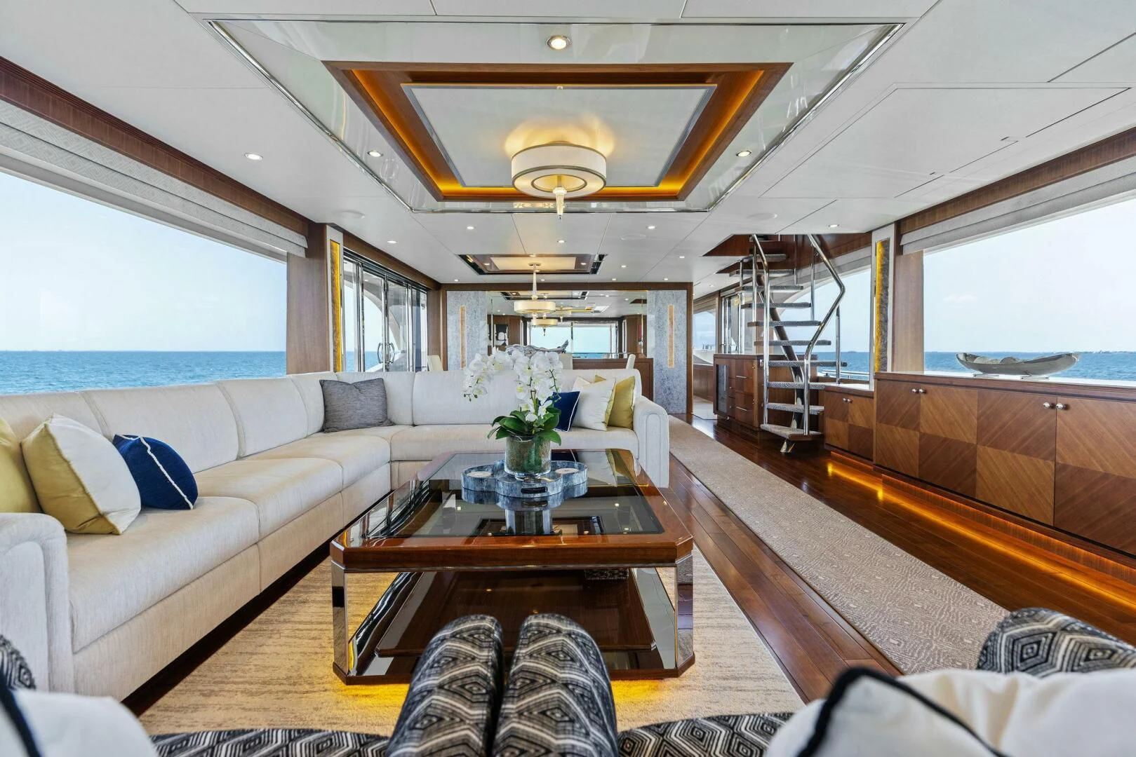 a living room with a large window aboard CLAYMAKER Yacht for Sale