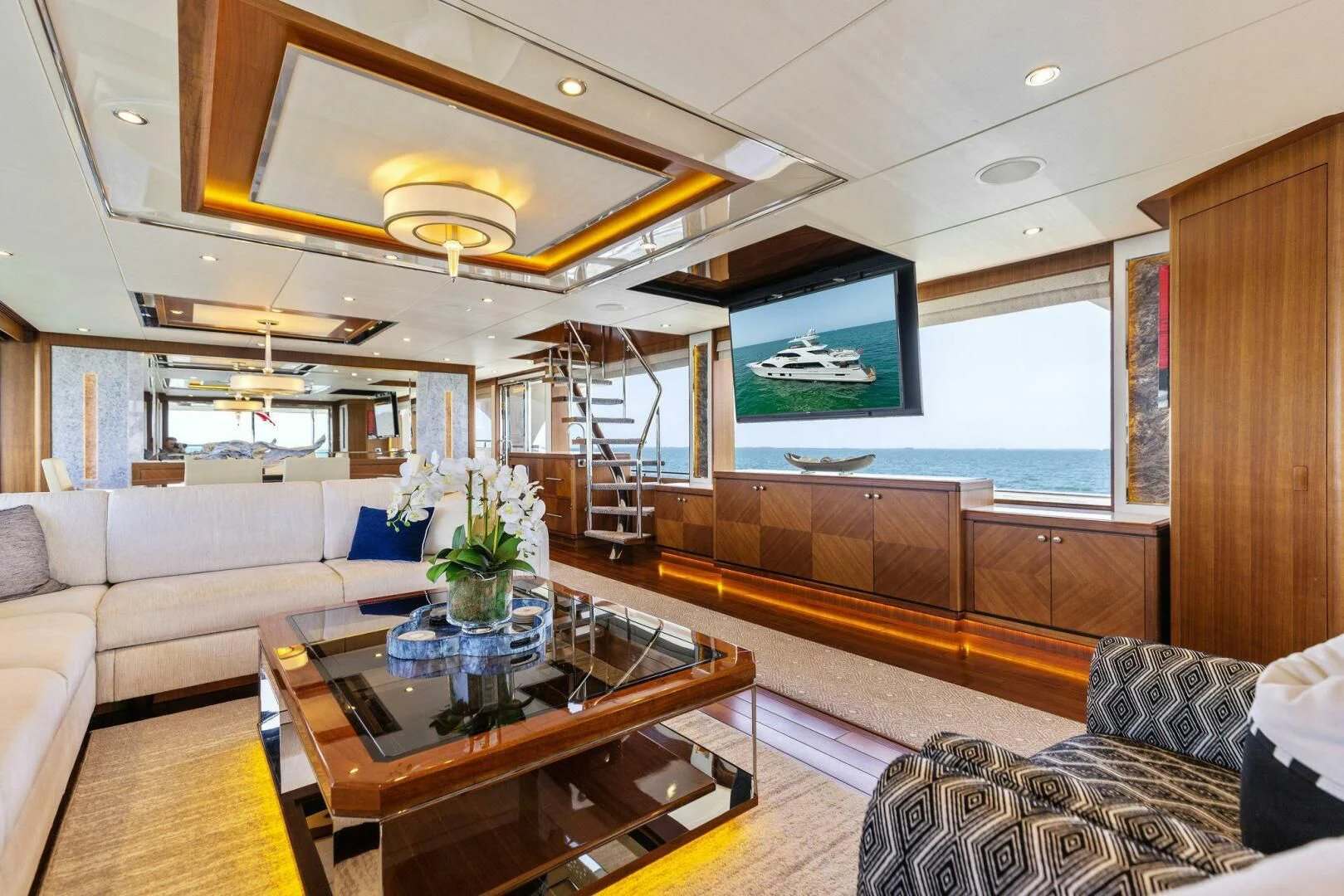 a living room with a large window aboard CLAYMAKER Yacht for Sale