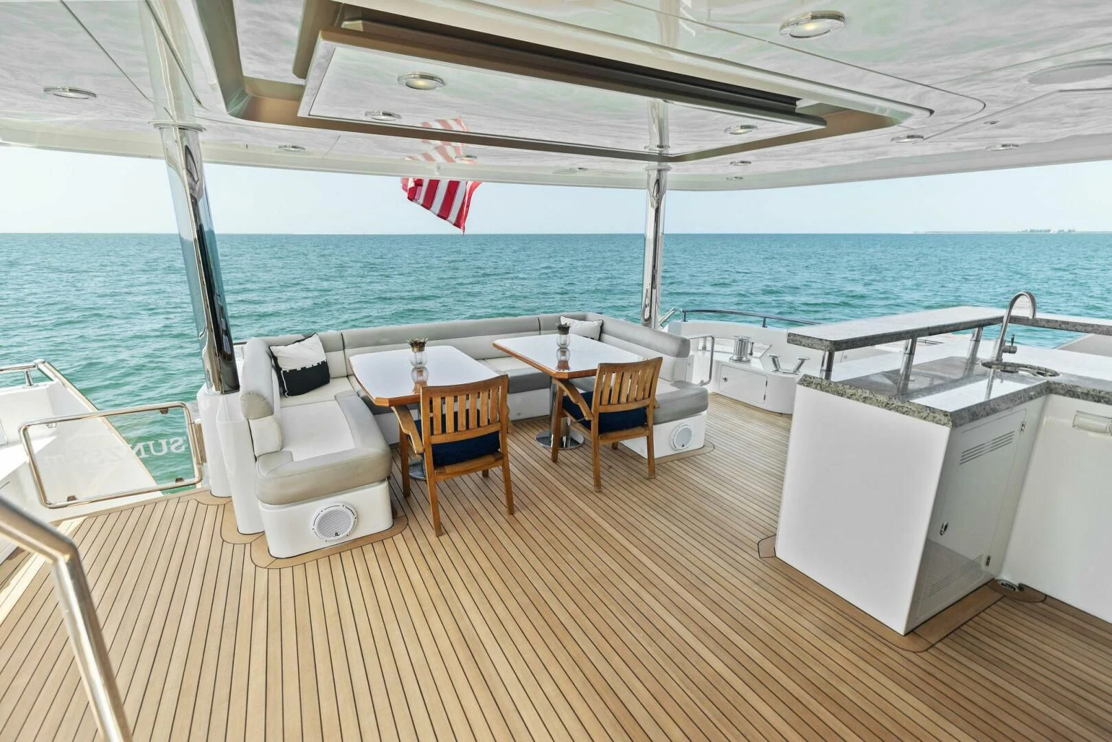 a deck with chairs and tables on it aboard CLAYMAKER Yacht for Sale