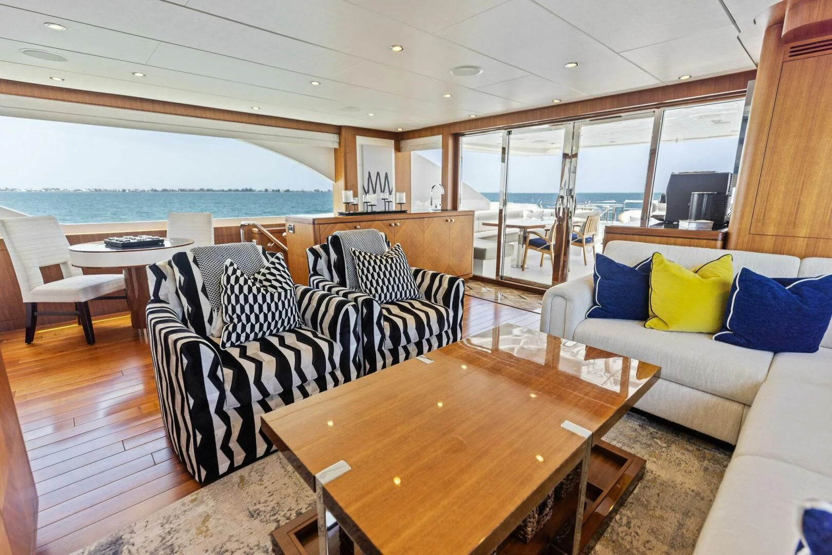 a living room with a table and chairs aboard CLAYMAKER Yacht for Sale