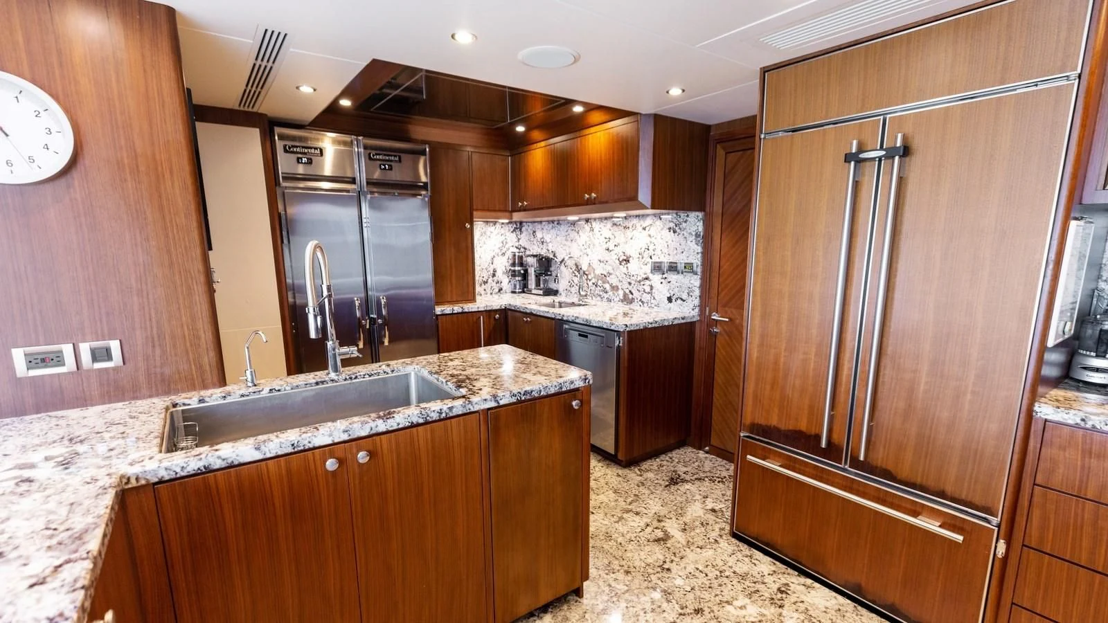 a kitchen with a stainless steel refrigerator aboard CLAYMAKER Yacht for Sale