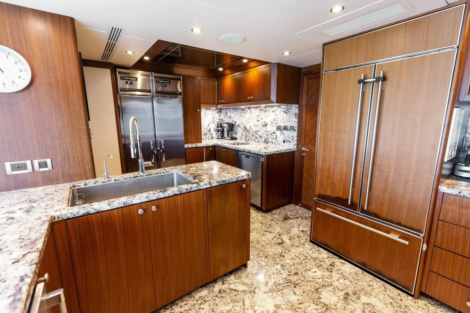 a kitchen with a large island aboard CLAYMAKER Yacht for Sale