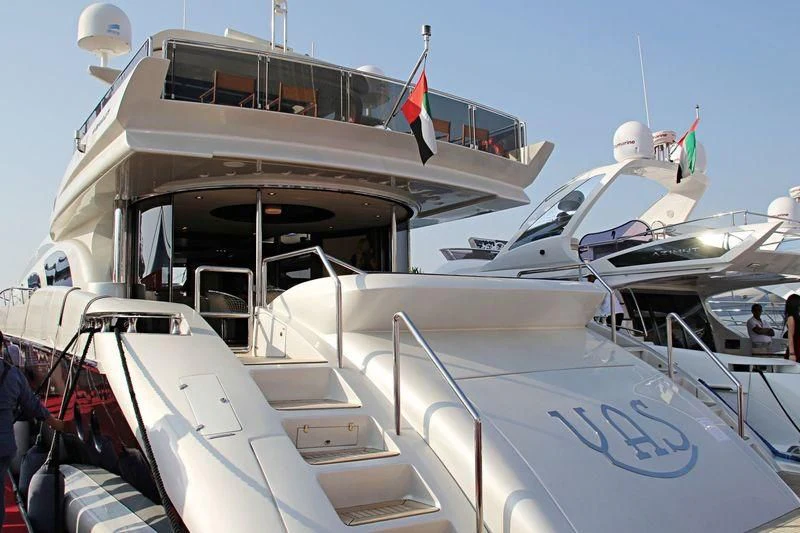 a boat with a flag on the front aboard YAS Yacht for Sale