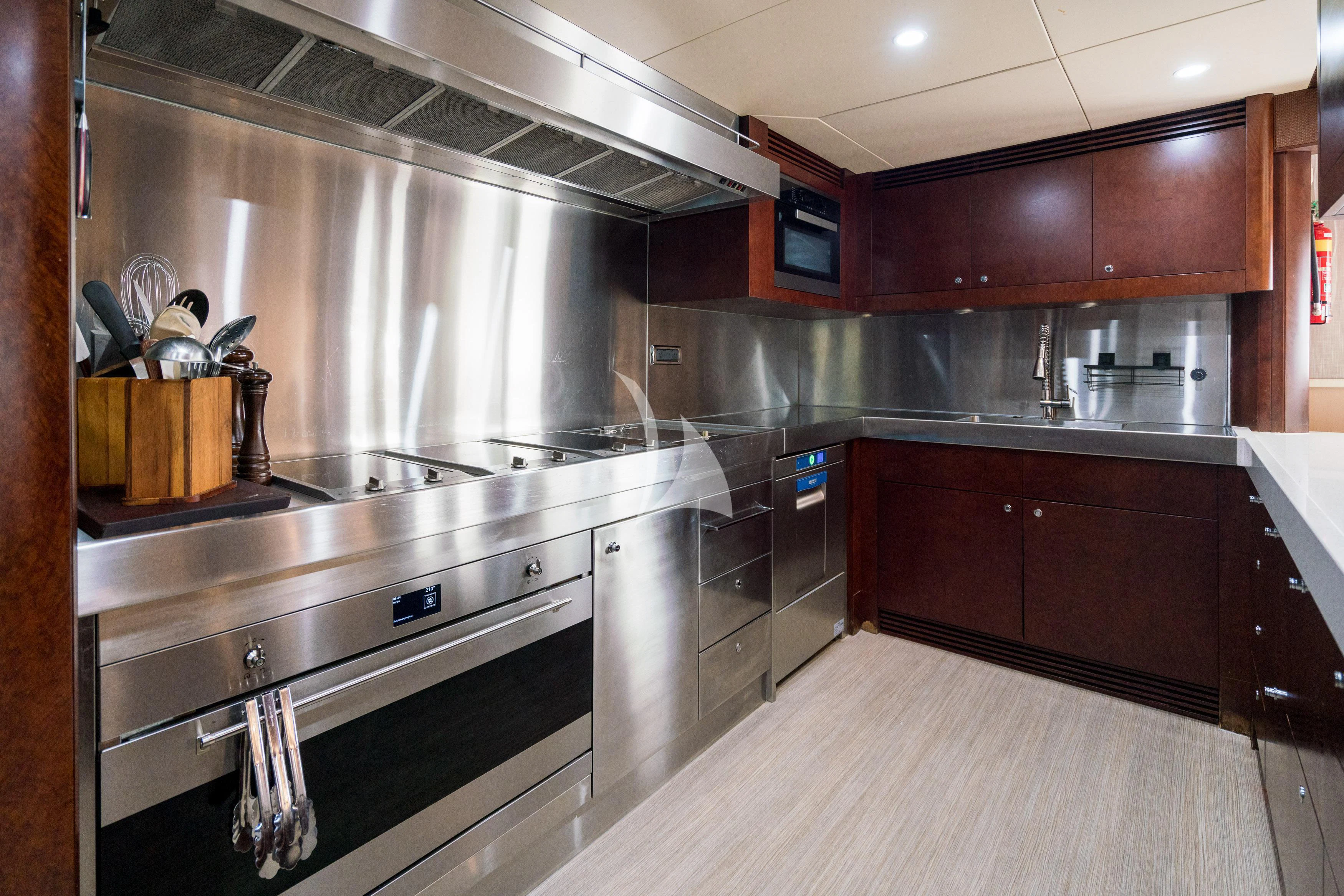 a kitchen with stainless steel appliances aboard DE LISLE III Yacht for Sale