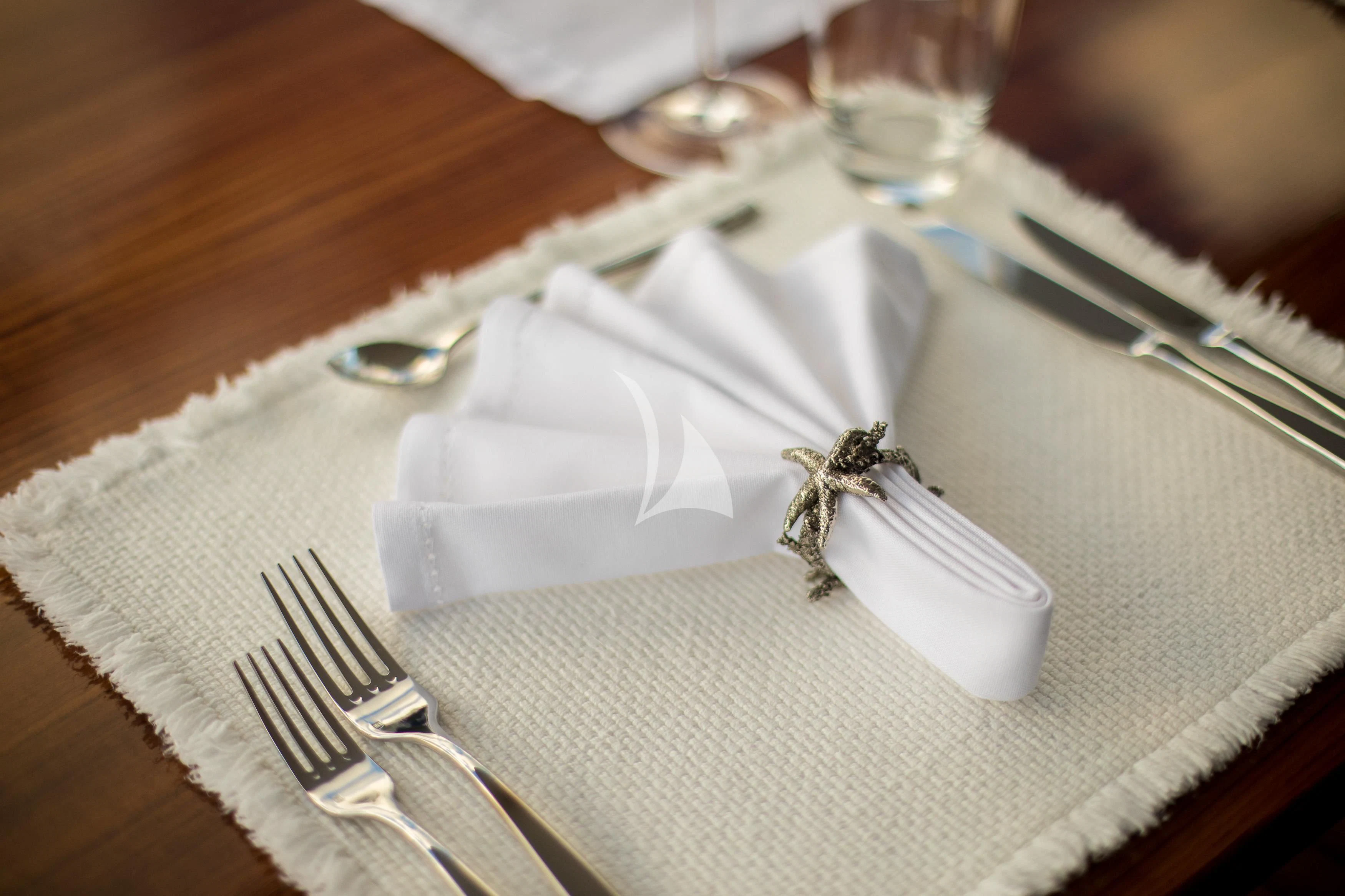 a white napkin on a plate aboard DE LISLE III Yacht for Sale