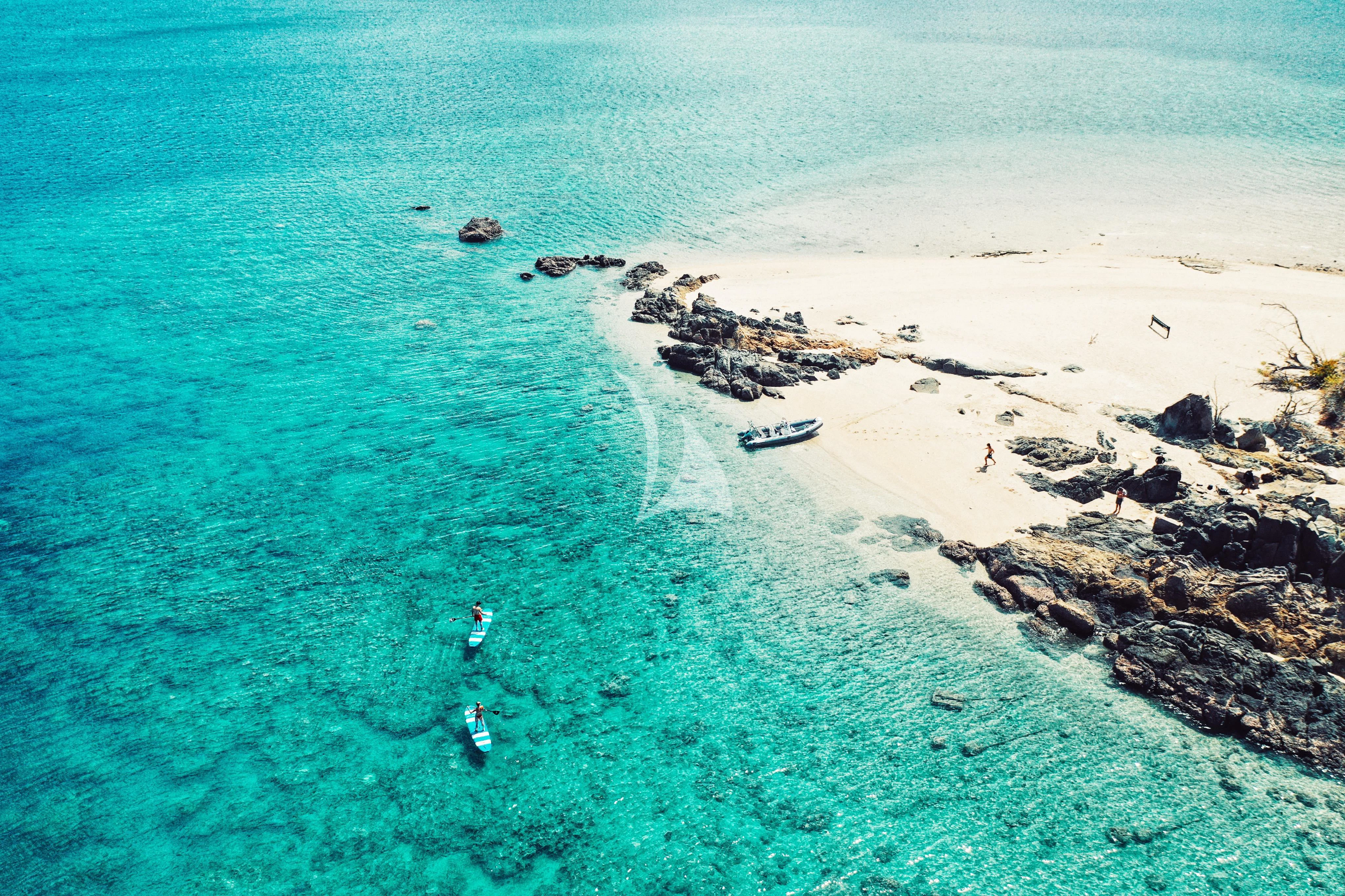 a beach with rocks and water aboard DE LISLE III Yacht for Sale