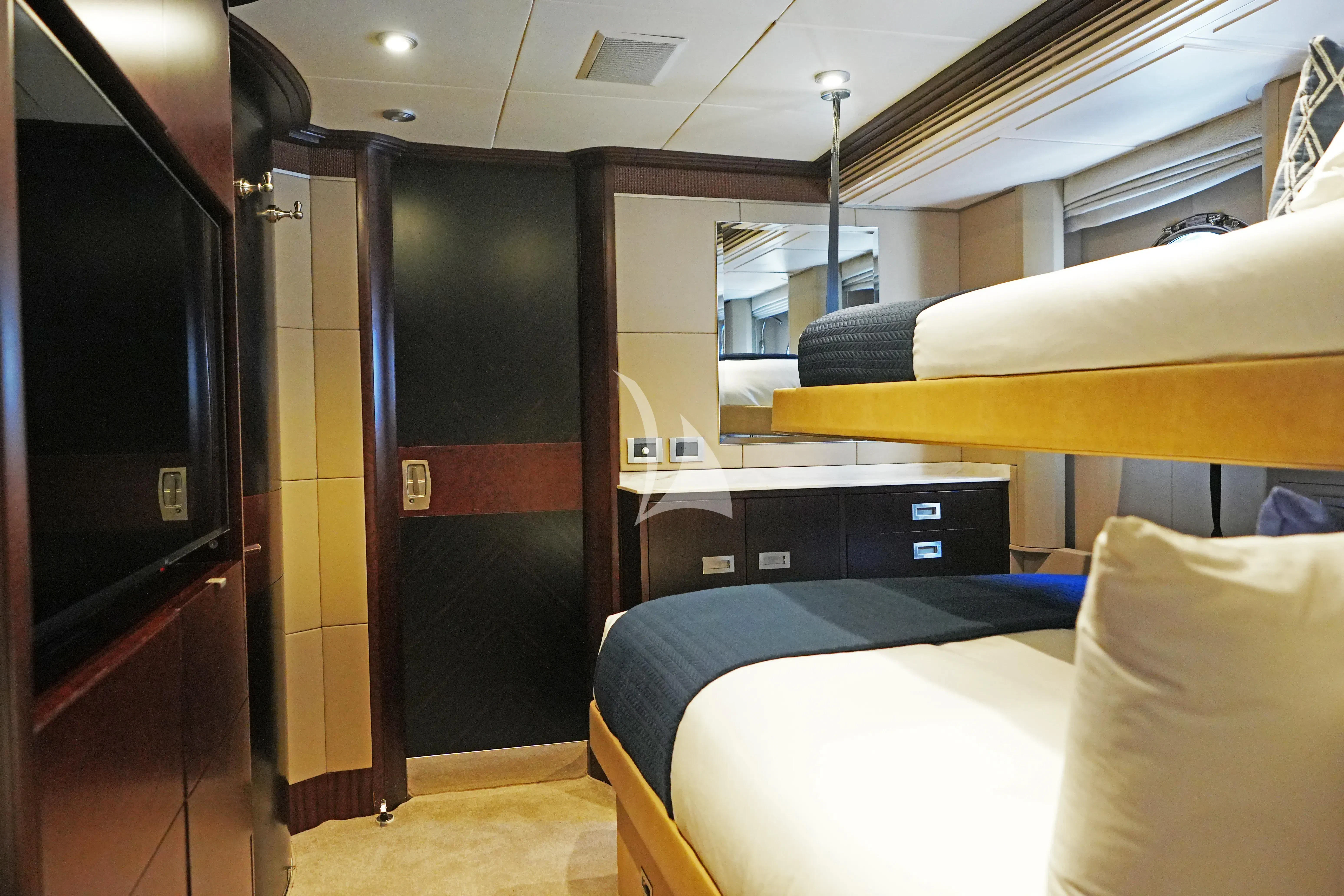 a room with a bed and desk aboard DE LISLE III Yacht for Sale