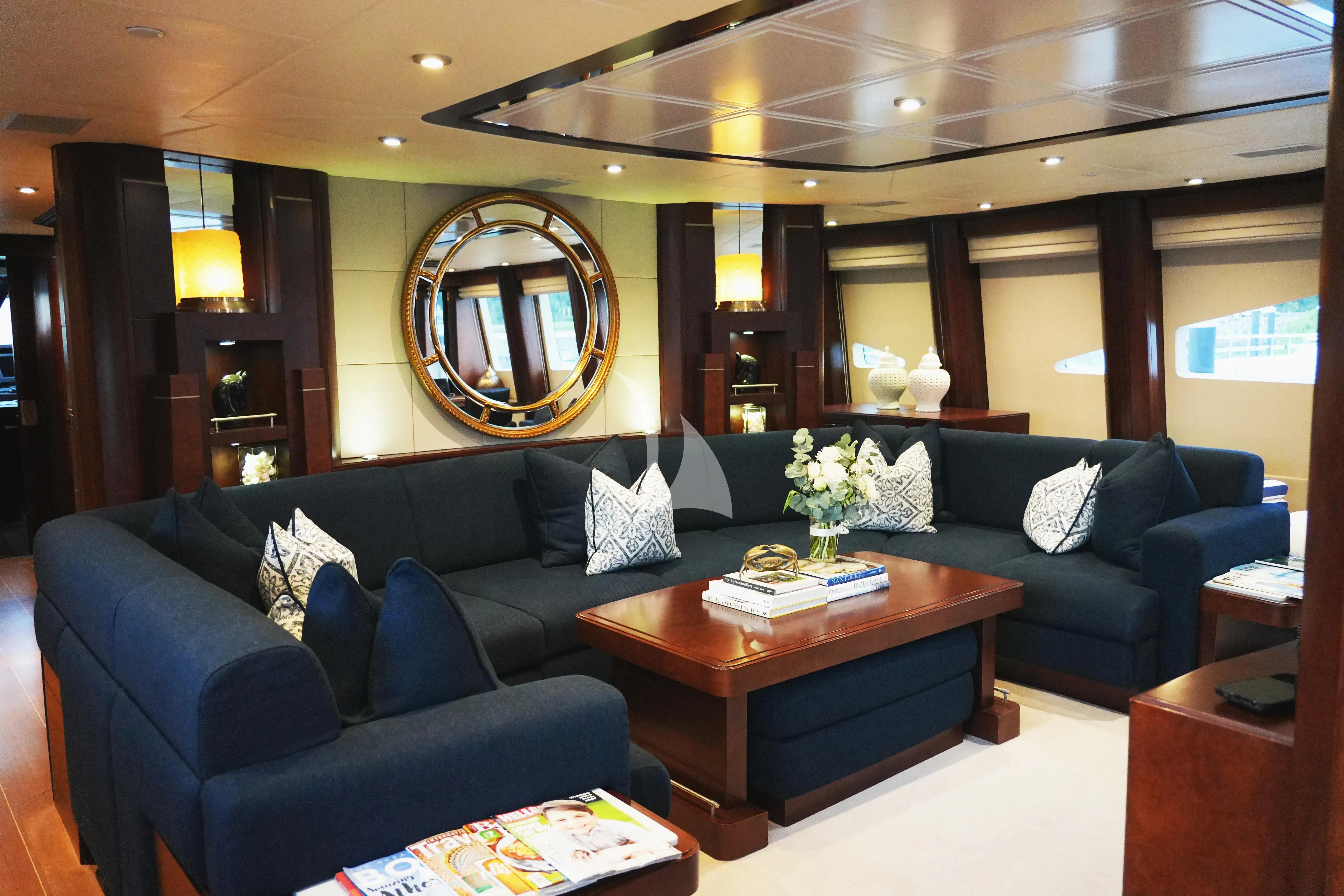 a living room with a blue couch aboard DE LISLE III Yacht for Sale