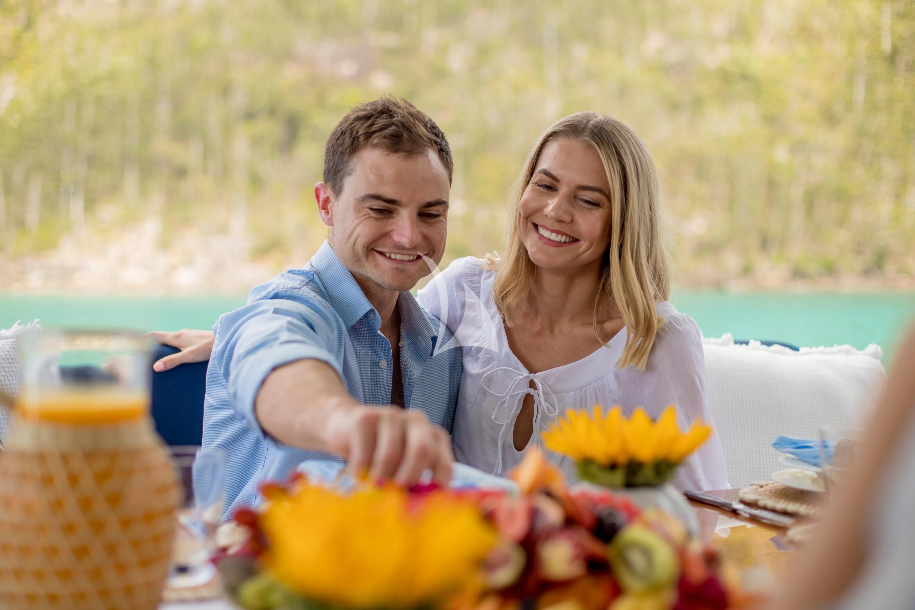 a man and woman sitting at a table with food aboard DE LISLE III Yacht for Sale