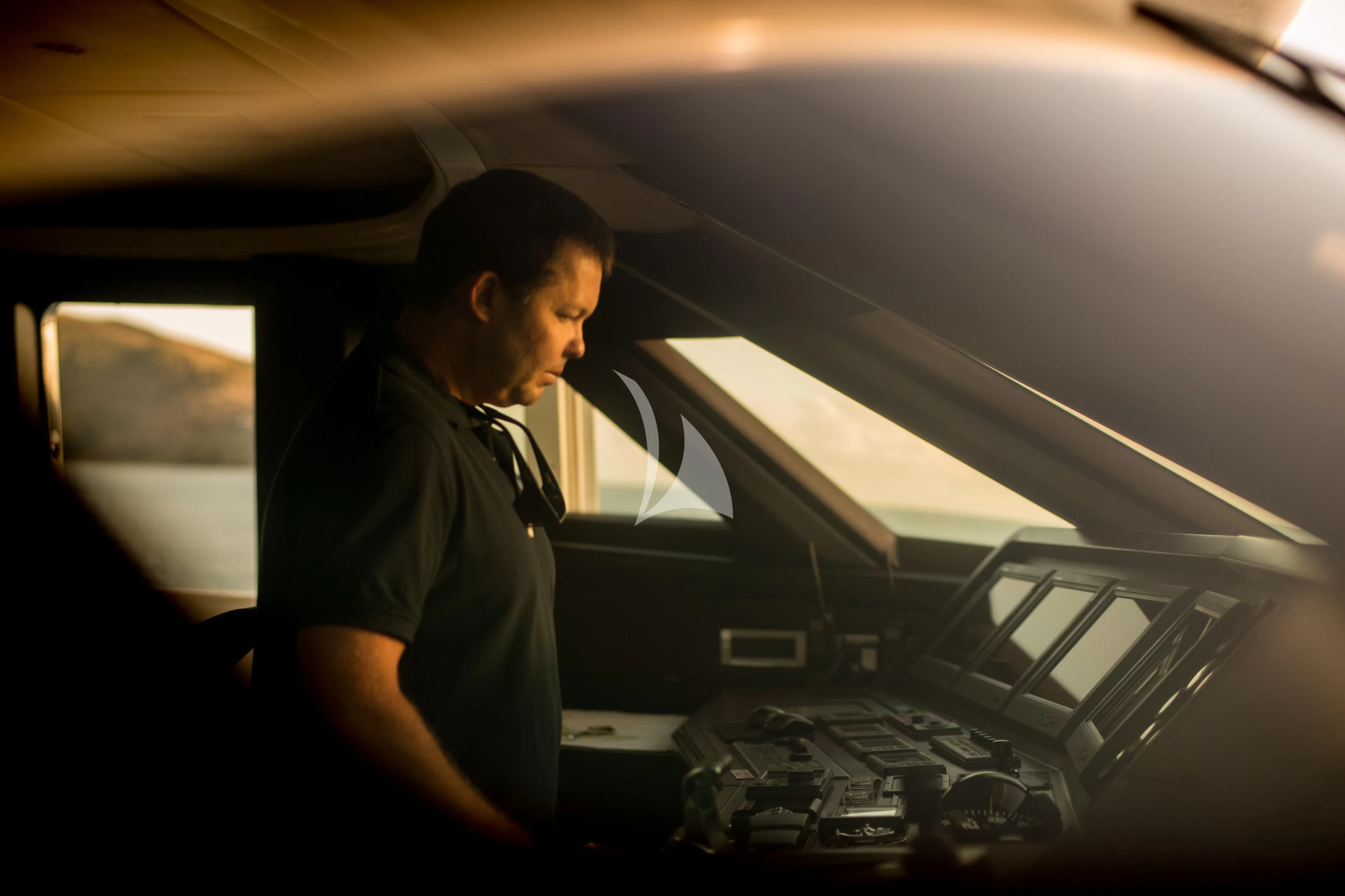 a man in a car aboard DE LISLE III Yacht for Sale