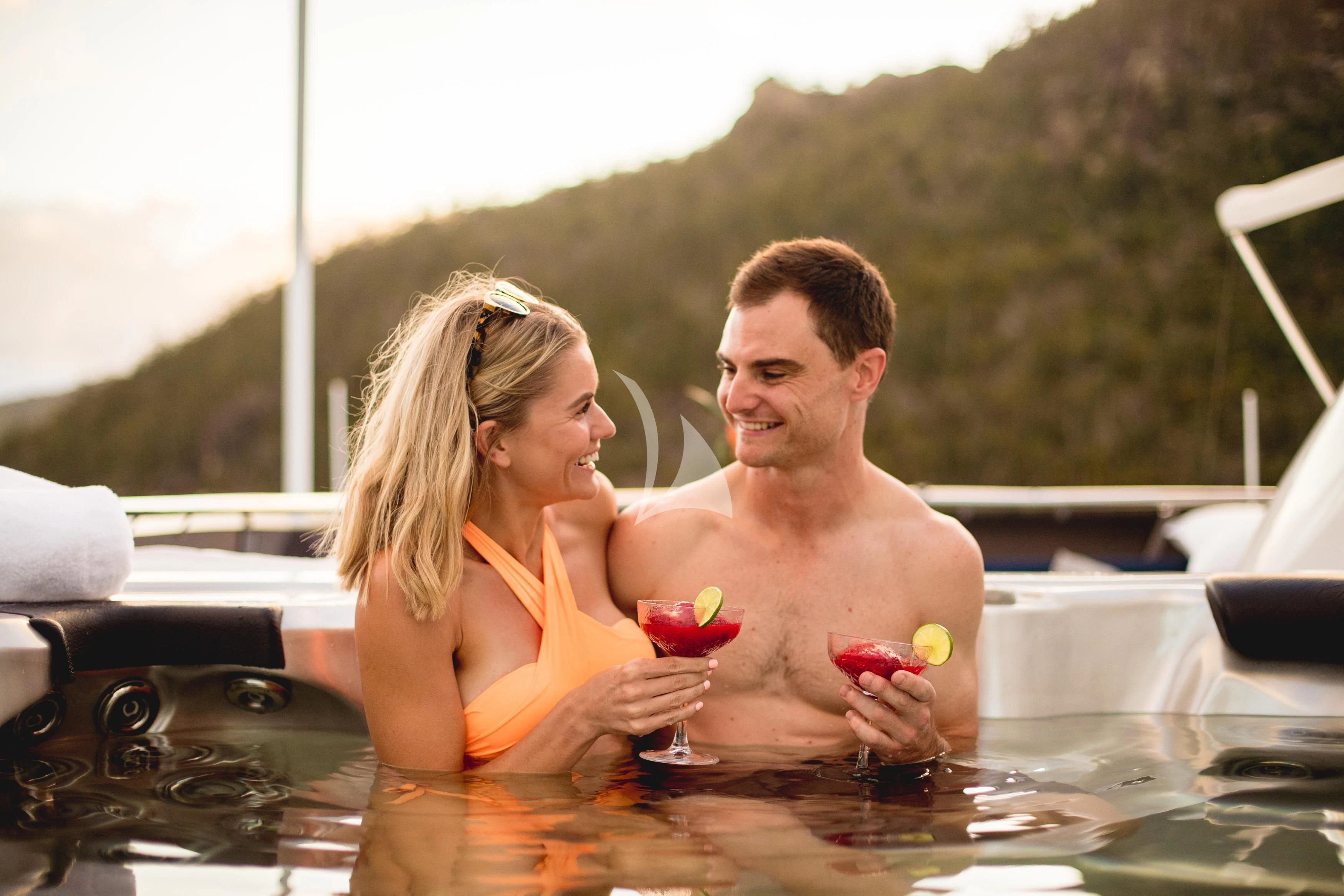 a man and woman in a pool aboard DE LISLE III Yacht for Sale
