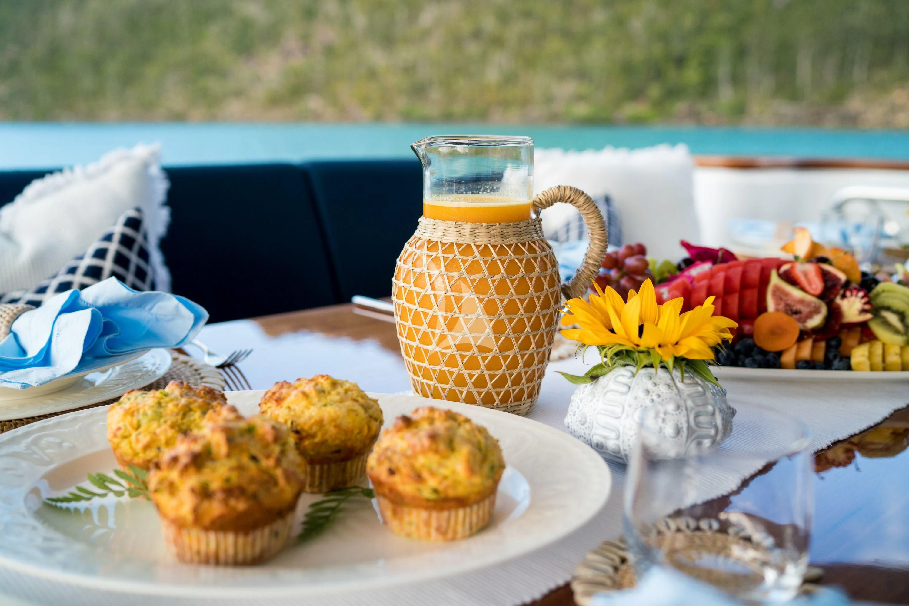 a table with muffins and flowers on it aboard DE LISLE III Yacht for Sale