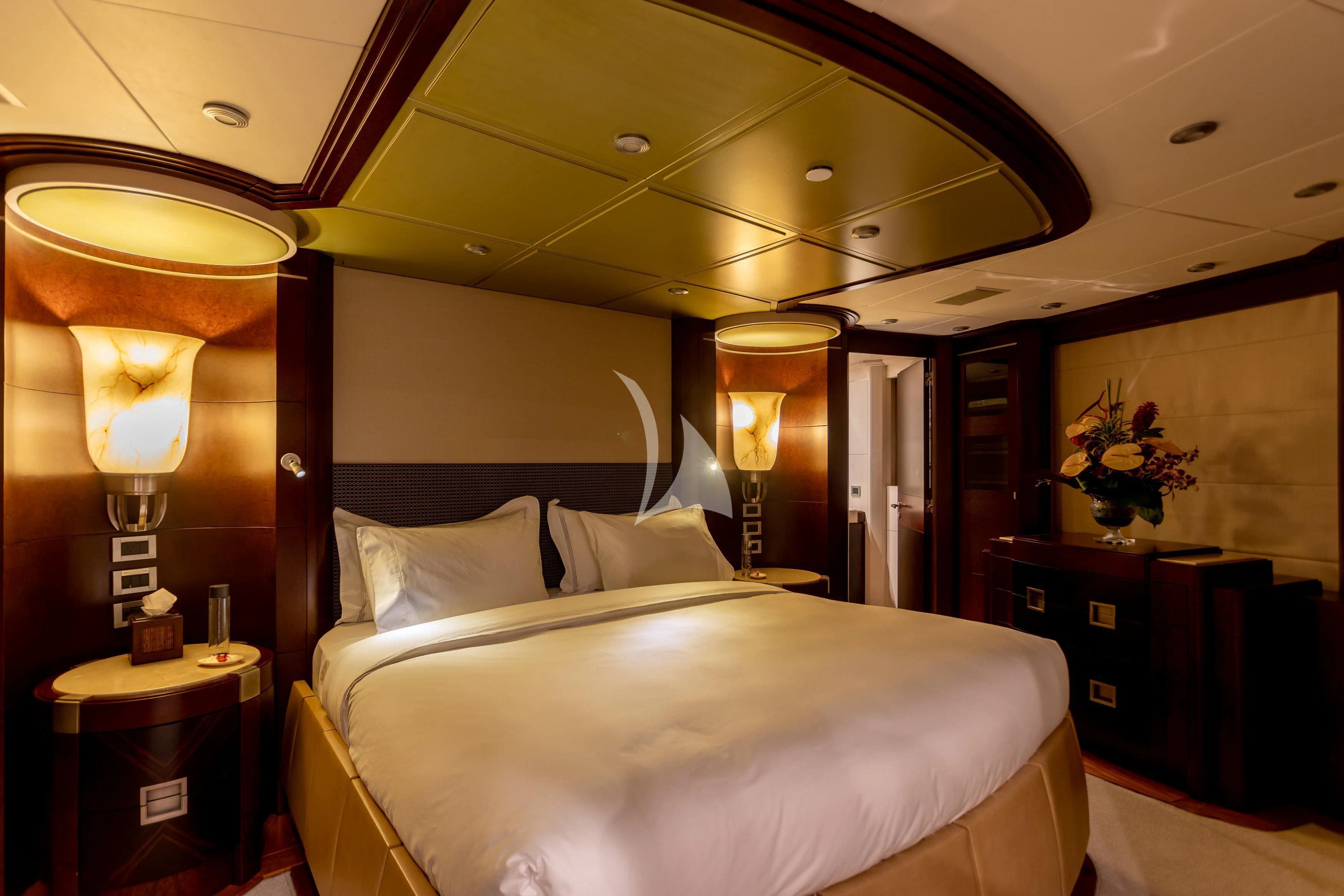 a hotel room with a bed and lamps aboard DE LISLE III Yacht for Sale