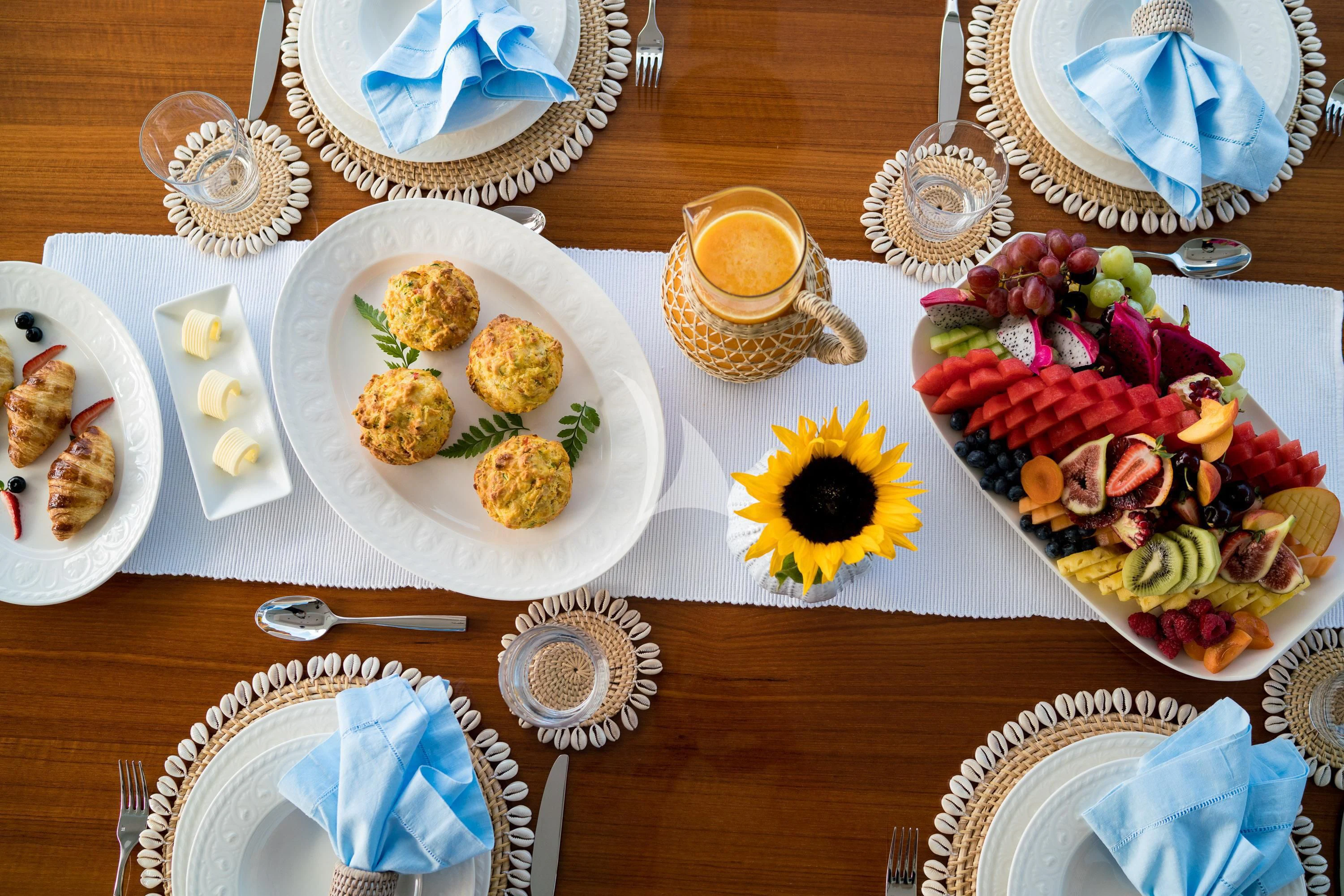 a table with plates of food and cups of coffee aboard DE LISLE III Yacht for Sale